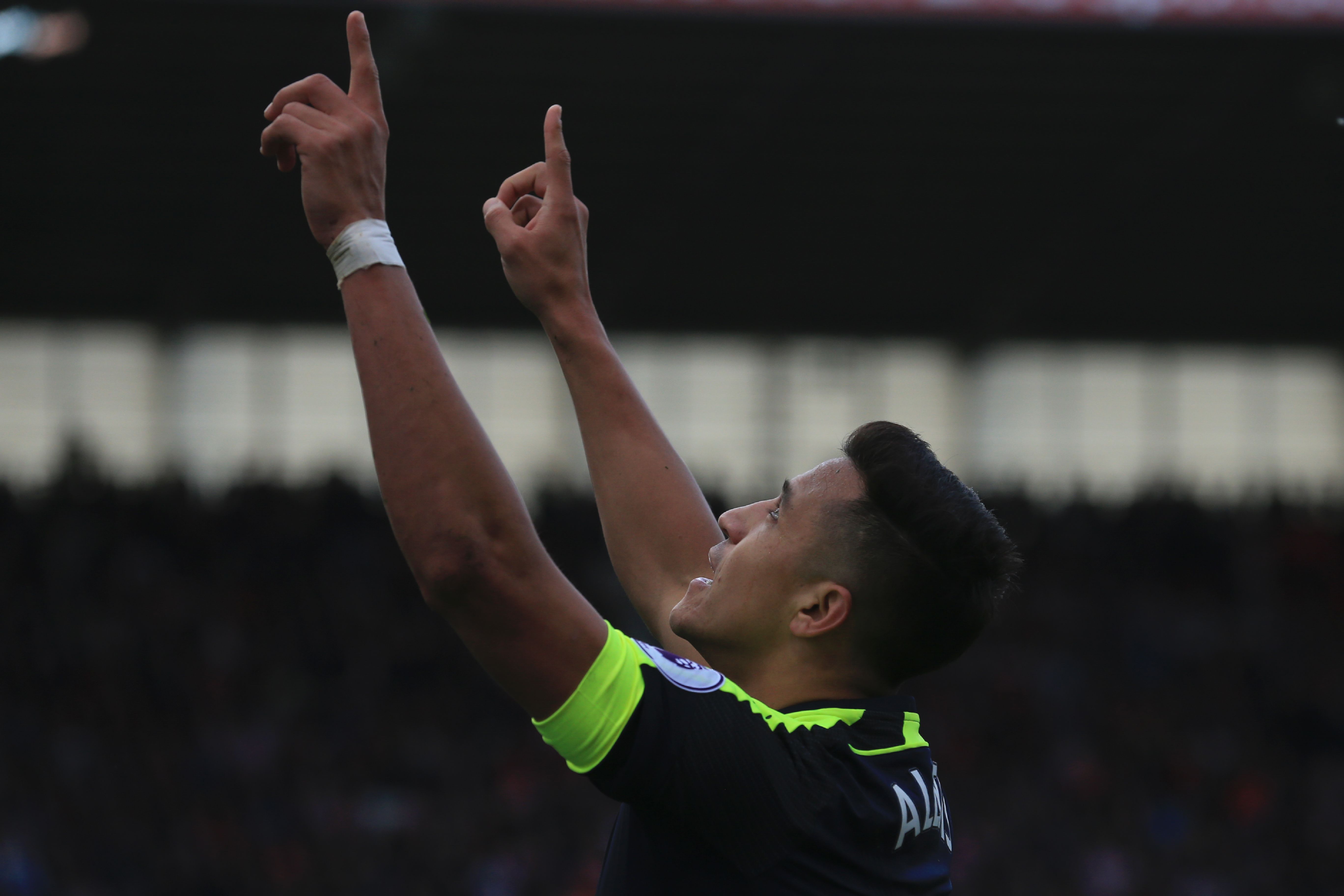 Arsenal's Chilean striker Alexis Sanchez celebrates after scoring their third goal during the English Premier League football match between Stoke City and Arsenal at the Bet365 Stadium in Stoke-on-Trent, central England on May 13, 2017.
Arsenal won the game 4-1. / AFP PHOTO / Lindsey PARNABY / RESTRICTED TO EDITORIAL USE. No use with unauthorized audio, video, data, fixture lists, club/league logos or 'live' services. Online in-match use limited to 75 images, no video emulation. No use in betting, games or single club/league/player publications.  /         (Photo credit should read LINDSEY PARNABY/AFP/Getty Images)