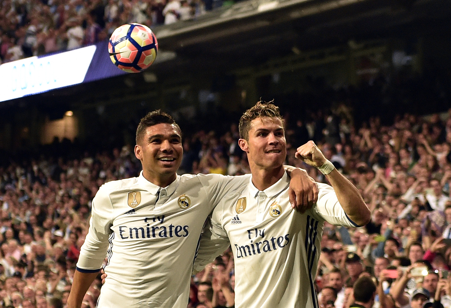 Real Madrid's Portuguese forward Cristiano Ronaldo (R) celebrates a goal with Real Madrid's Brazilian midfielder Casemiro during the Spanish league football match Real Madrid CF vs Sevilla FC at the Santiago Bernabeu stadium in Madrid on May 14, 2017. / AFP PHOTO / GERARD JULIEN        (Photo credit should read GERARD JULIEN/AFP/Getty Images)