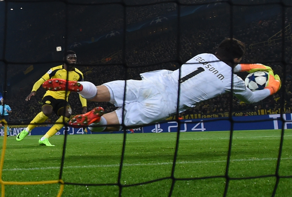 Benfica's Brazilian goalkeeper Ederson Moraes makes a save during the UEFA Champions League Round of 16, 2nd-leg football match Borussia Dortmund v SL Benfica in Dortmund, western Germany on March 8, 2017. / AFP PHOTO / PATRIK STOLLARZ        (Photo credit should read PATRIK STOLLARZ/AFP/Getty Images)