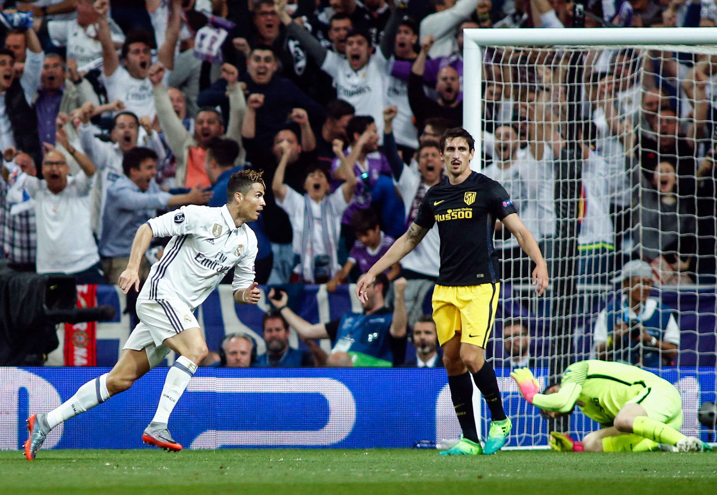 Real Madrid's Portuguese forward Cristiano Ronaldo (L) runs after scoring a goal during the UEFA Champions League semifinal first leg football match Real Madrid CF vs Club Atletico de Madrid at the Santiago Bernabeu stadium in Madrid, on May 2, 2017. / AFP PHOTO / OSCAR DEL POZO        (Photo credit should read OSCAR DEL POZO/AFP/Getty Images)