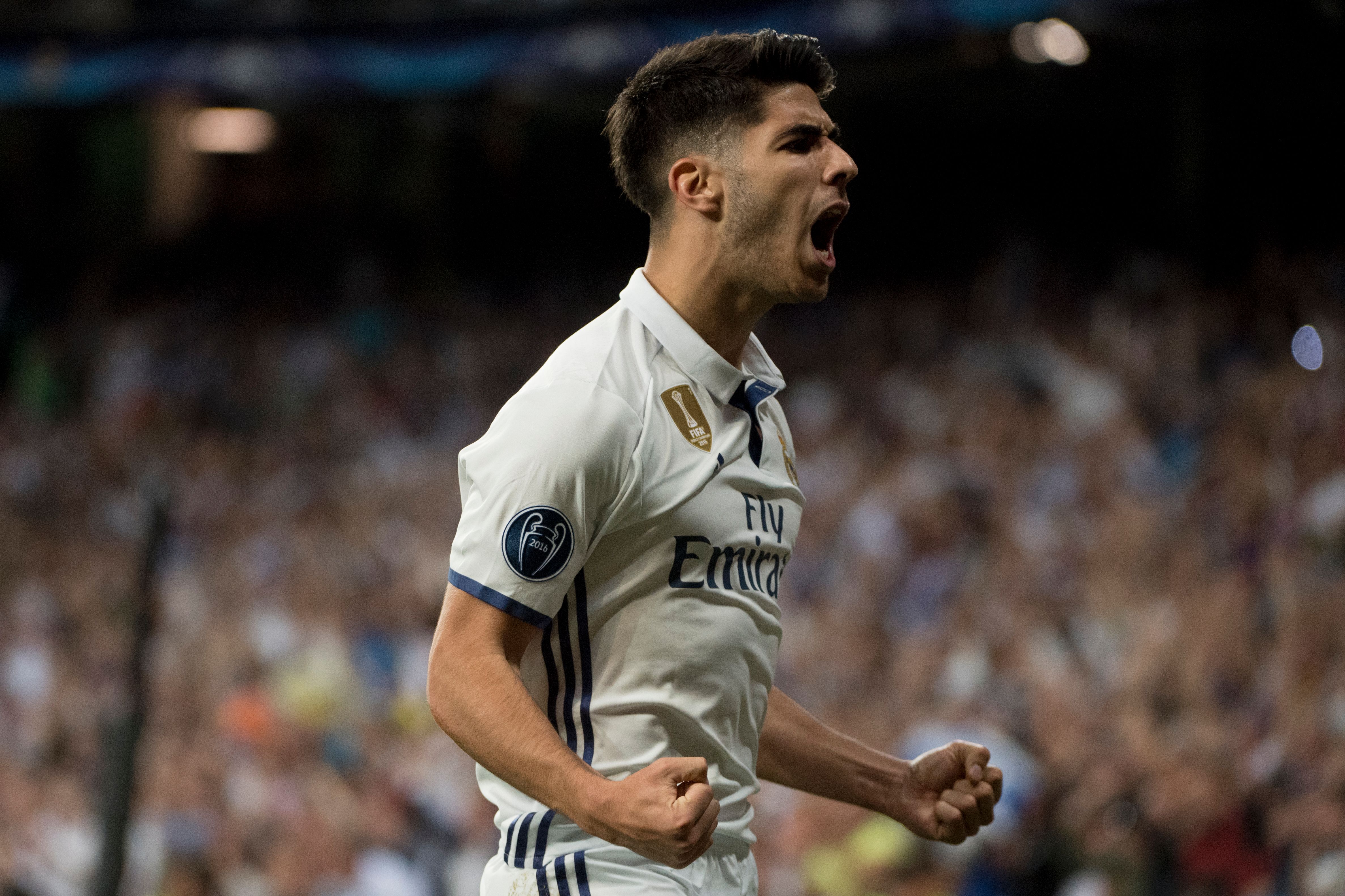 Real Madrid's midfielder Marco Asensio celebrates scoring during the UEFA Champions League quarter-final second leg football match Real Madrid vs FC Bayern Munich at the Santiago Bernabeu stadium in Madrid in Madrid on April 18, 2017. / AFP PHOTO / CURTO DE LA TORRE        (Photo credit should read CURTO DE LA TORRE/AFP/Getty Images)