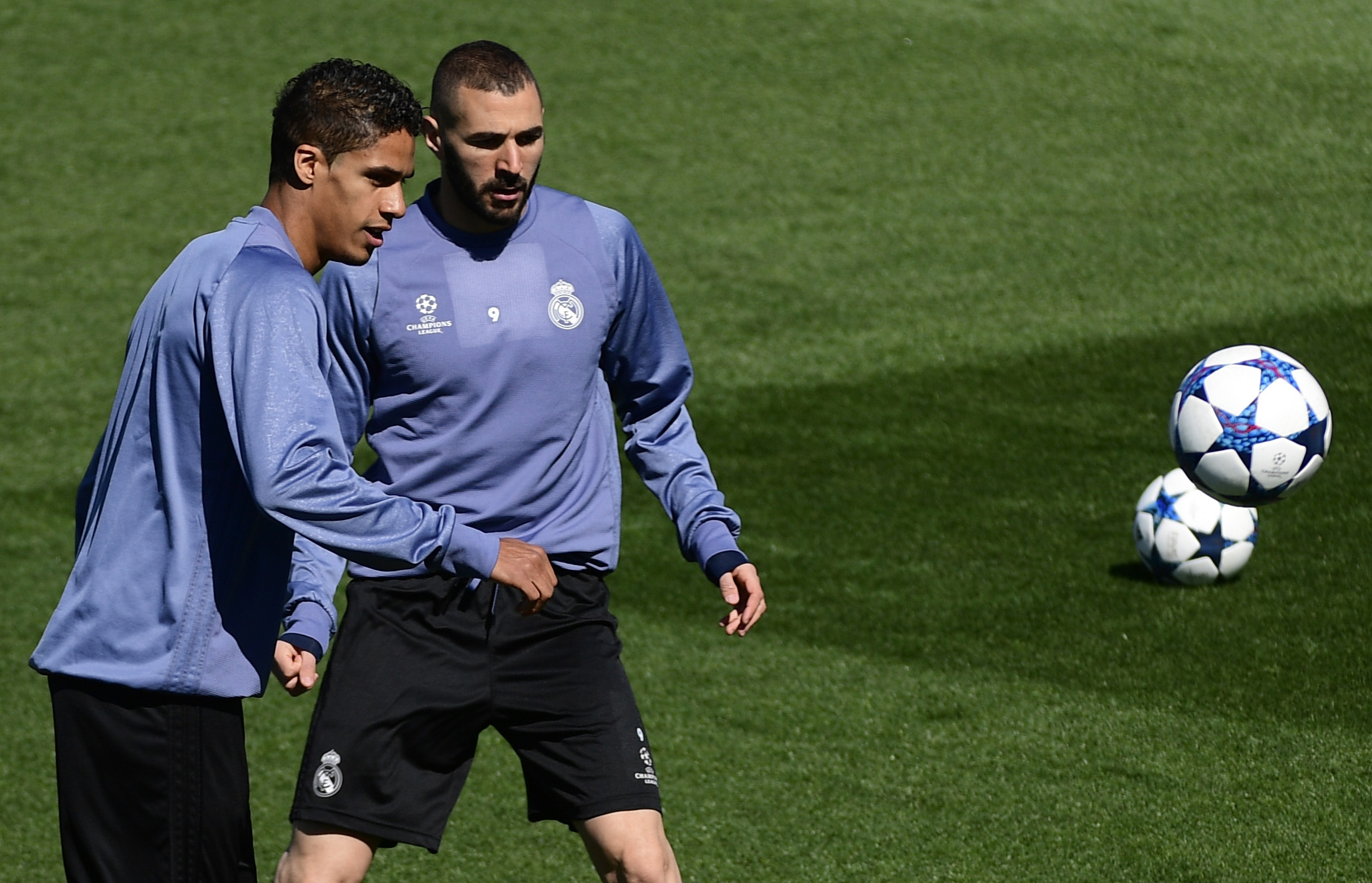 Real Madrid's French defender Raphael Varane (L) and Real Madrid's French forward Karim Benzema attend a training session at Valdebebas Sport City in Madrid on May 1, 2017 on the eve of their Champions' League semi-final first leg football match against Atletico de Madrid. / AFP PHOTO / PIERRE-PHILIPPE MARCOU        (Photo credit should read PIERRE-PHILIPPE MARCOU/AFP/Getty Images)