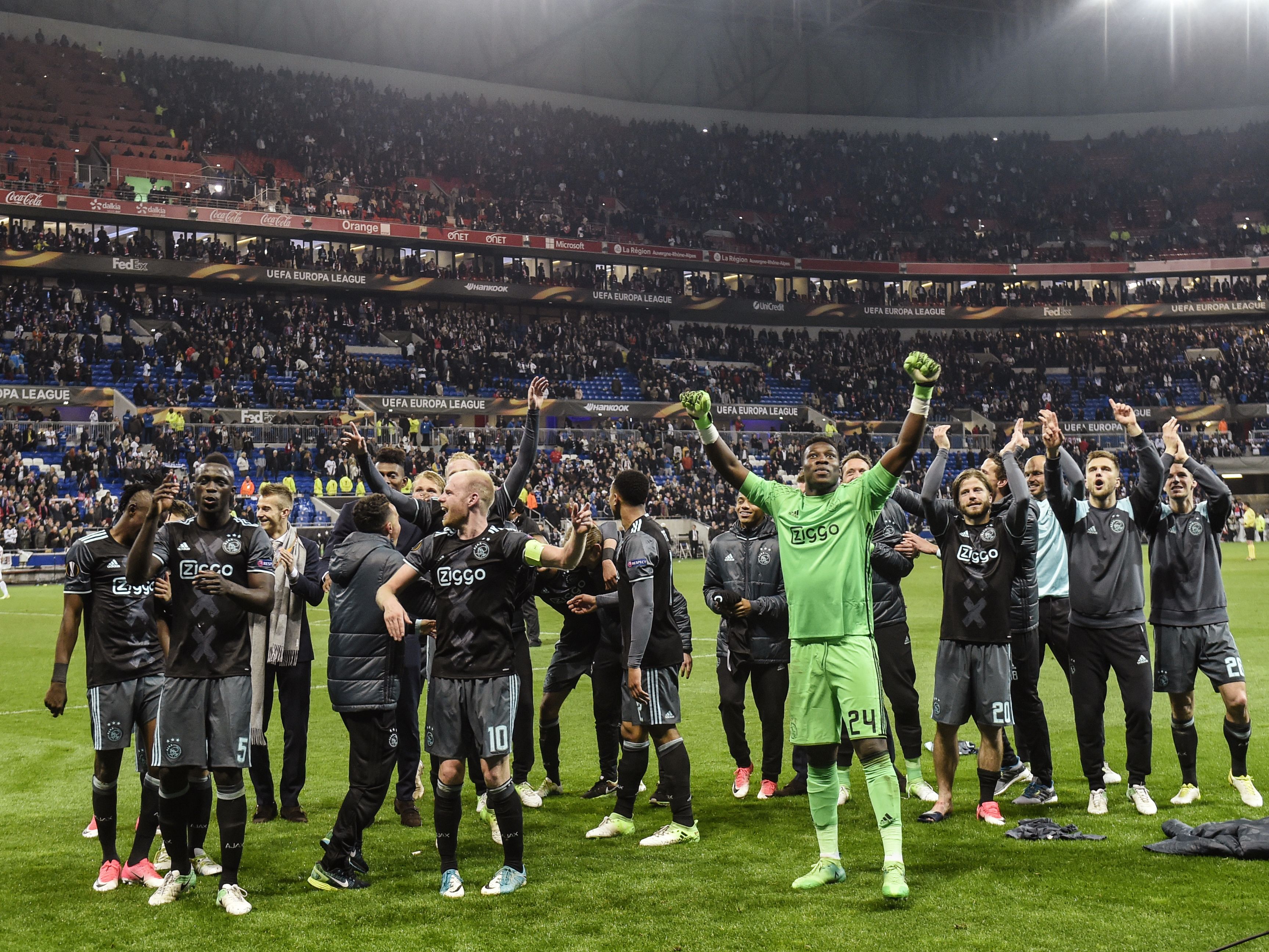 Ajax' players celebrate their victory in the Europa League semi-final football match Olympique Lyonnais against AFC Ajax, on May 11, 2017 at the Parc Olympique Lyonnais stadium in Décines-Charpieu near Lyon, southeastern France.    / AFP PHOTO / PHILIPPE DESMAZES        (Photo credit should read PHILIPPE DESMAZES/AFP/Getty Images)