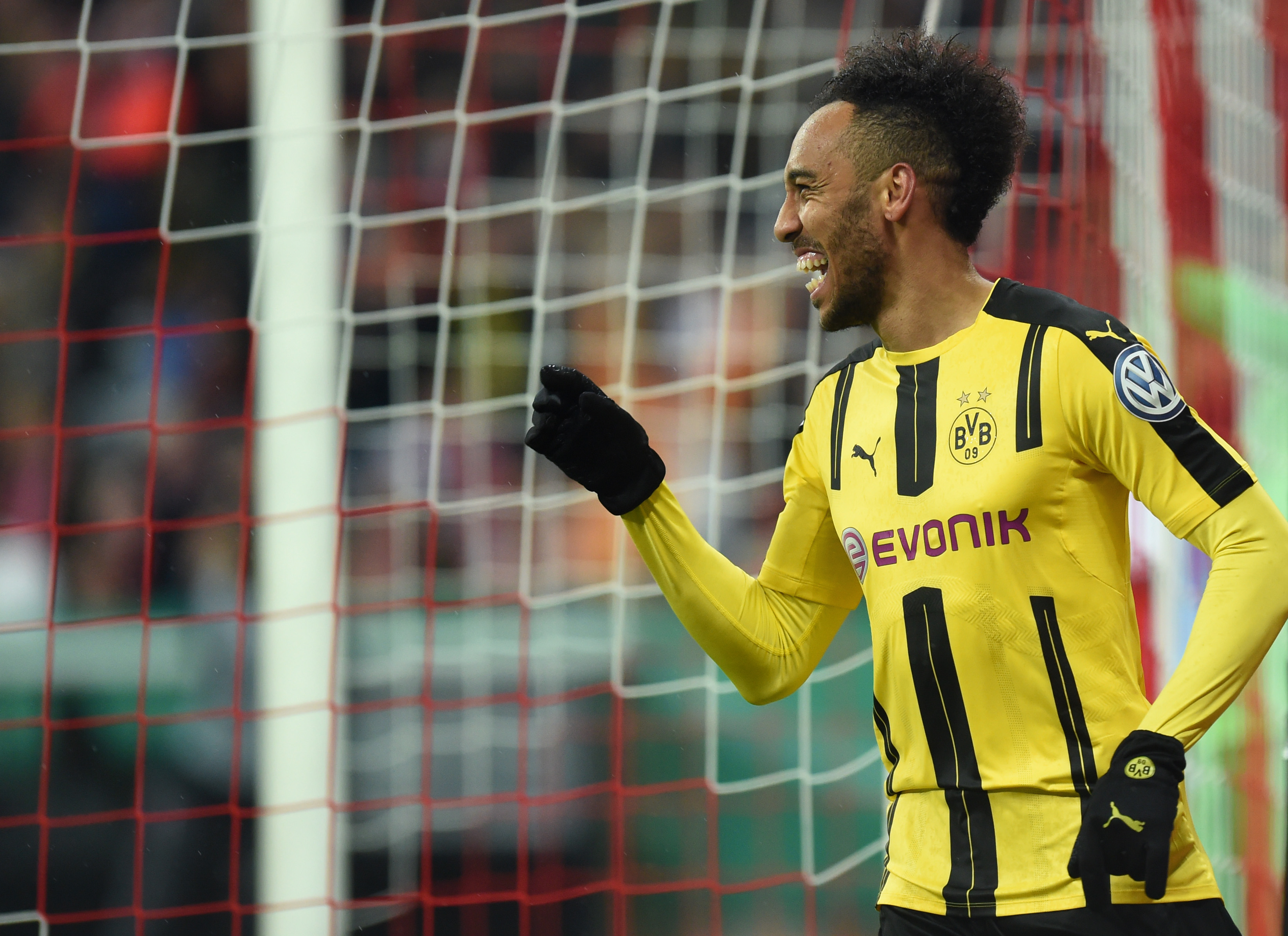 Dortmund's Gabonese striker Pierre-Emerick Aubameyang celebrates after the second goal during the German Cup DFB Pokal semifinal football match between FC Bayern Munich and BVB Borussia Dortmund in Munich, on April 26, 2017. / AFP PHOTO / Christof STACHE / RESTRICTIONS: ACCORDING TO DFB RULES IMAGE SEQUENCES TO SIMULATE VIDEO IS NOT ALLOWED DURING MATCH TIME. MOBILE (MMS) USE IS NOT ALLOWED DURING AND FOR FURTHER TWO HOURS AFTER THE MATCH. == RESTRICTED TO EDITORIAL USE == FOR MORE INFORMATION CONTACT DFB DIRECTLY AT +49 69 67880

 /         (Photo credit should read CHRISTOF STACHE/AFP/Getty Images)