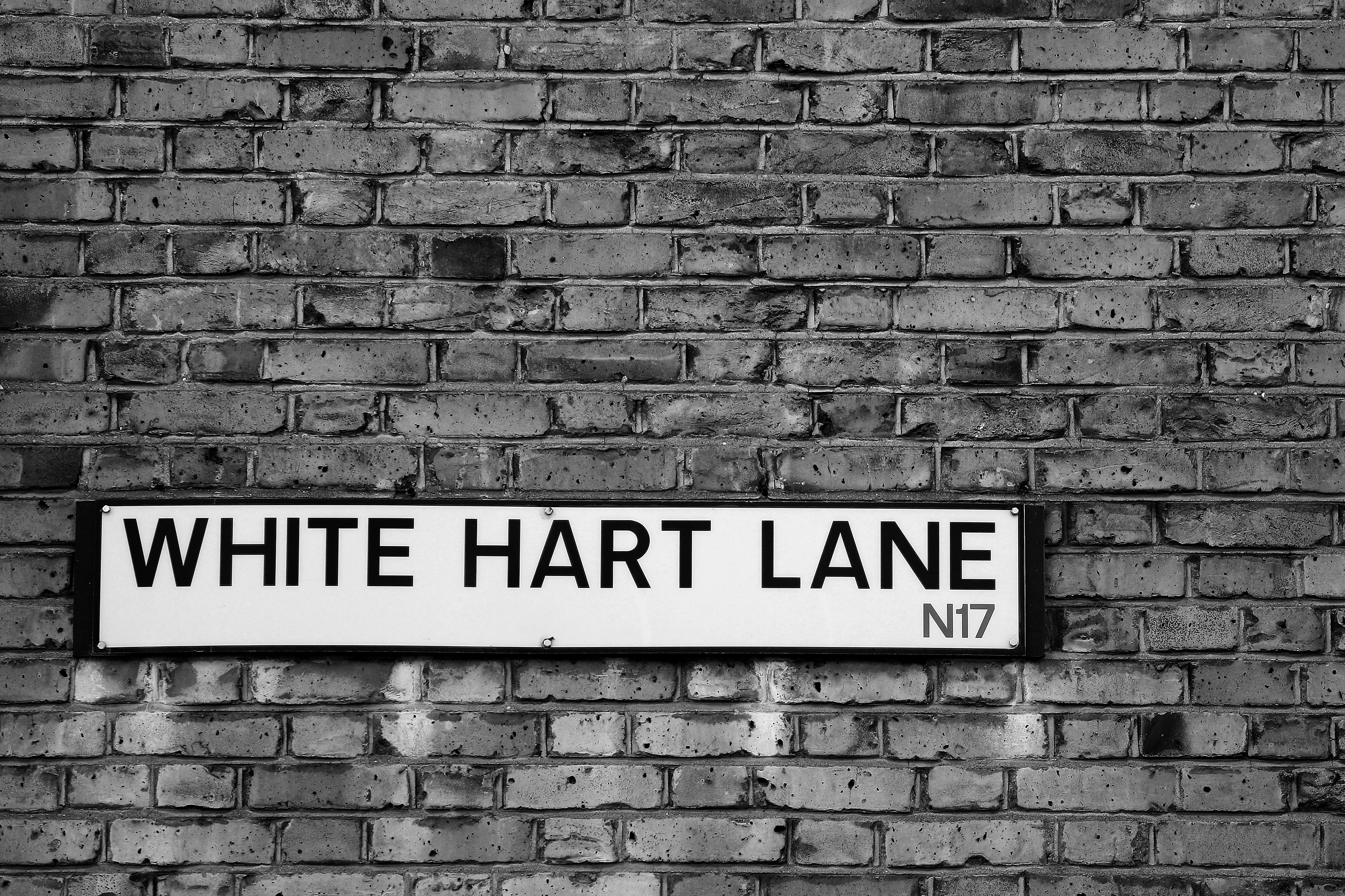 LONDON, ENGLAND - MAY 14:  (EDITORS NOTE: THIS IMAGE HAS BEEN CONVERTED TO BLACK & WHITE) The White Hart Lane street sign is seen prior to the Premier League match between Tottenham Hotspur and Manchester United at White Hart Lane on May 14, 2017 in London, England. Tottenham Hotspur are playing their last ever home match at White Hart Lane after their 112 year stay at the stadium. Spurs will play at Wembley Stadium next season with a move to a newly built stadium for the 2018-19 campaign. (Photo by Richard Heathcote/Getty Images )