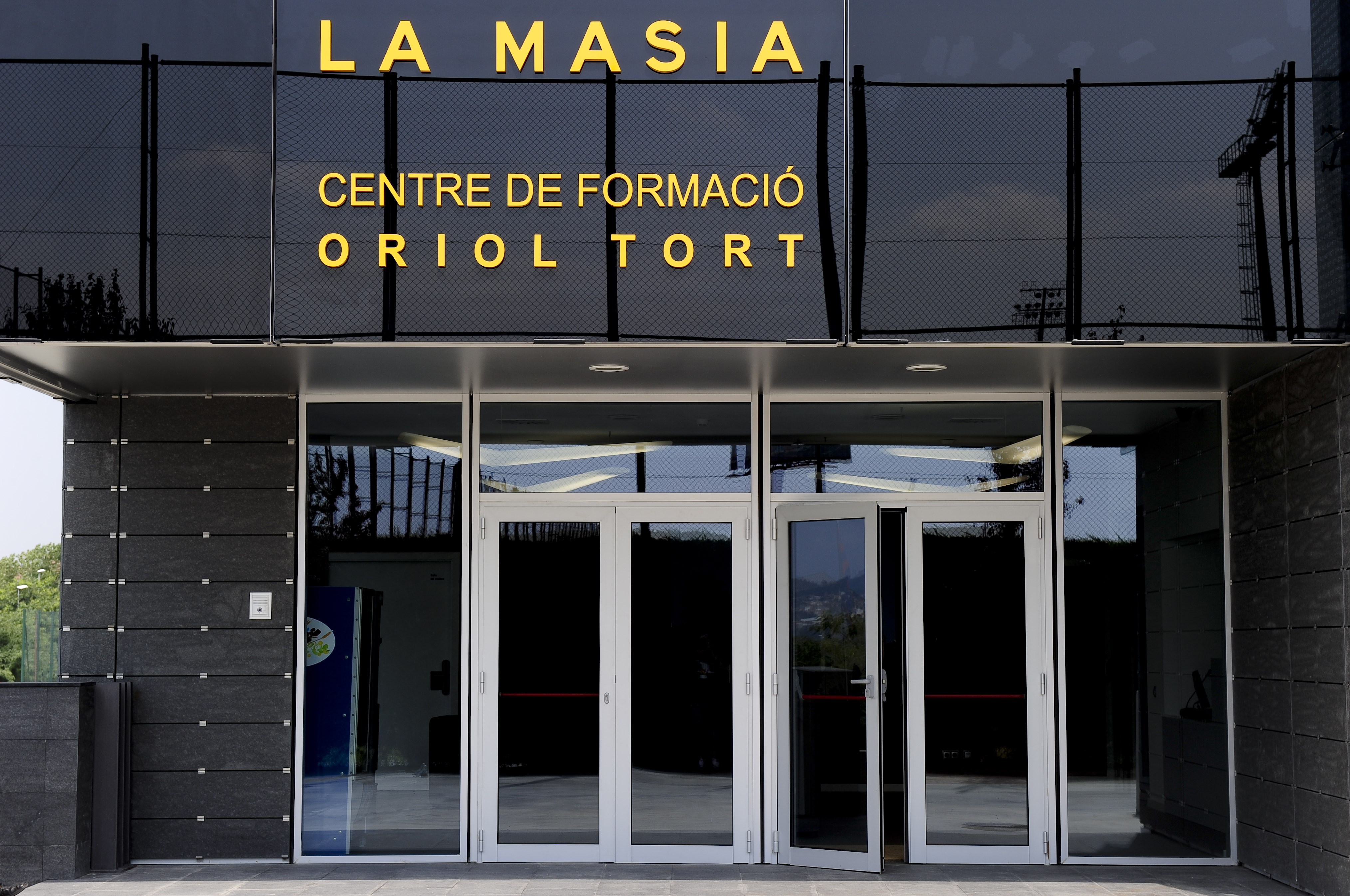 Entry of the new building named "La Masia" of the training centre Oriol Tort where young players of the Barcelona football club live and train, near the Camp Nou stadium in Barcelona  on August 5, 2011 .  AFP PHOTO/ JOSEP LAGO (Photo credit should read JOSEP LAGO/AFP/Getty Images)