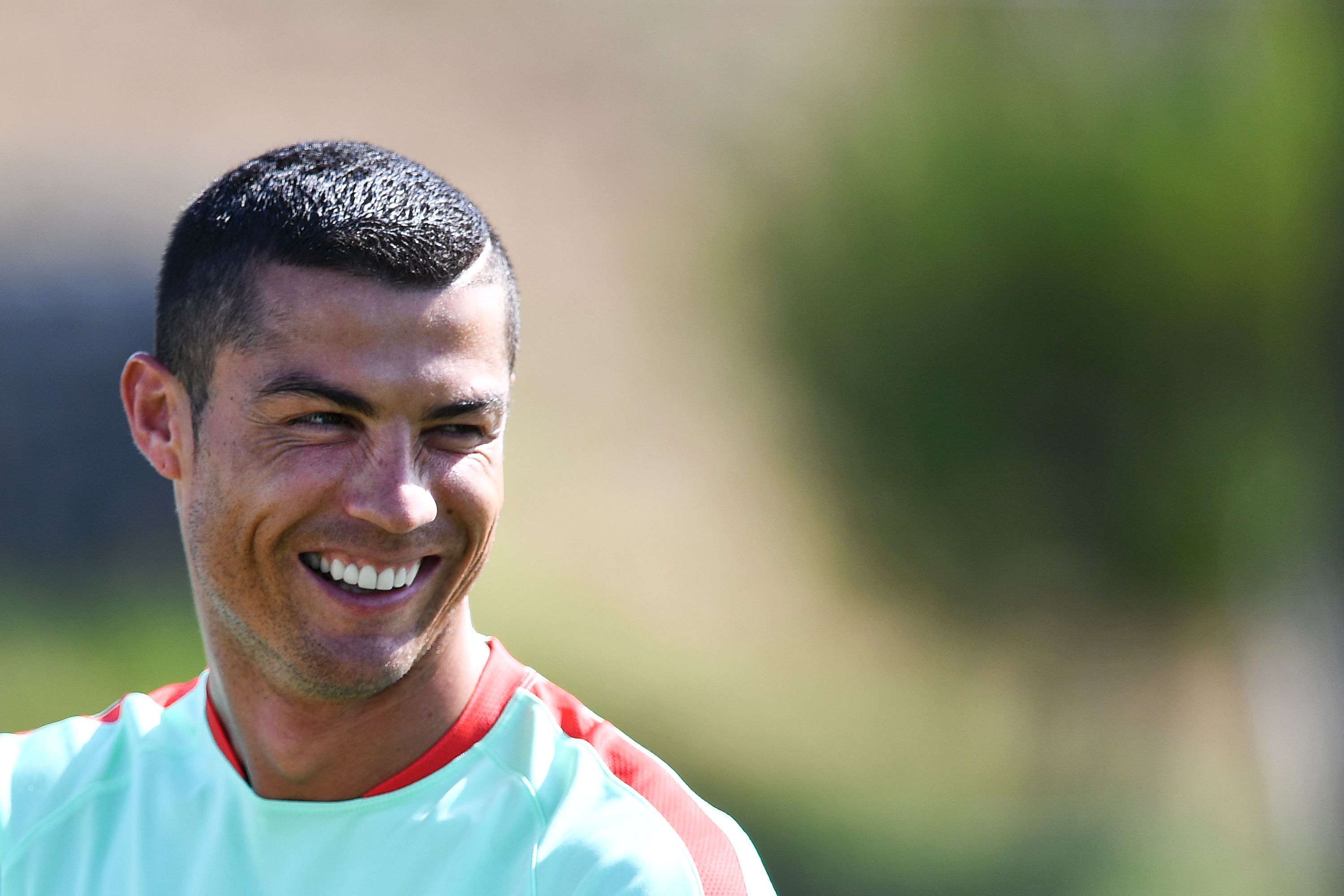 Portugal's forward Cristiano Ronaldo laughs during a training session at "Cidade do Futebol" training camp in Oeiras, outskirts of Lisbon, on June 14, 2017 ahead of the 2017 FIFA Confederations Cup football tournament in Russia which begins on June 17. / AFP PHOTO / PATRICIA DE MELO MOREIRA        (Photo credit should read PATRICIA DE MELO MOREIRA/AFP/Getty Images)