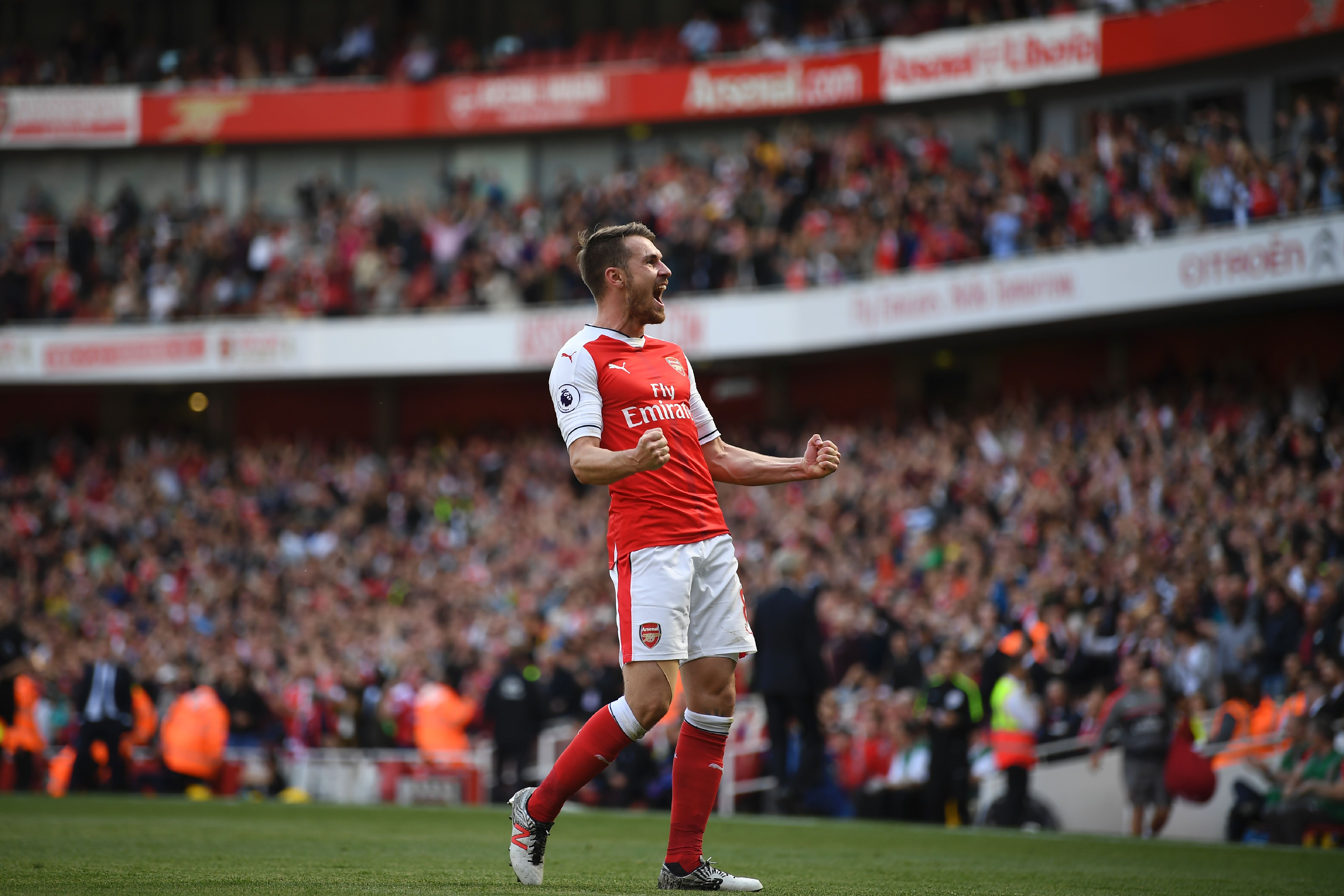 Arsenal's Welsh midfielder Aaron Ramsey celebrates scoring their third goal during the English Premier League football match between Arsenal and Everton at the Emirates Stadium in London on May 21, 2017.  / AFP PHOTO / Justin TALLIS / RESTRICTED TO EDITORIAL USE. No use with unauthorized audio, video, data, fixture lists, club/league logos or 'live' services. Online in-match use limited to 75 images, no video emulation. No use in betting, games or single club/league/player publications.  /         (Photo credit should read JUSTIN TALLIS/AFP/Getty Images)