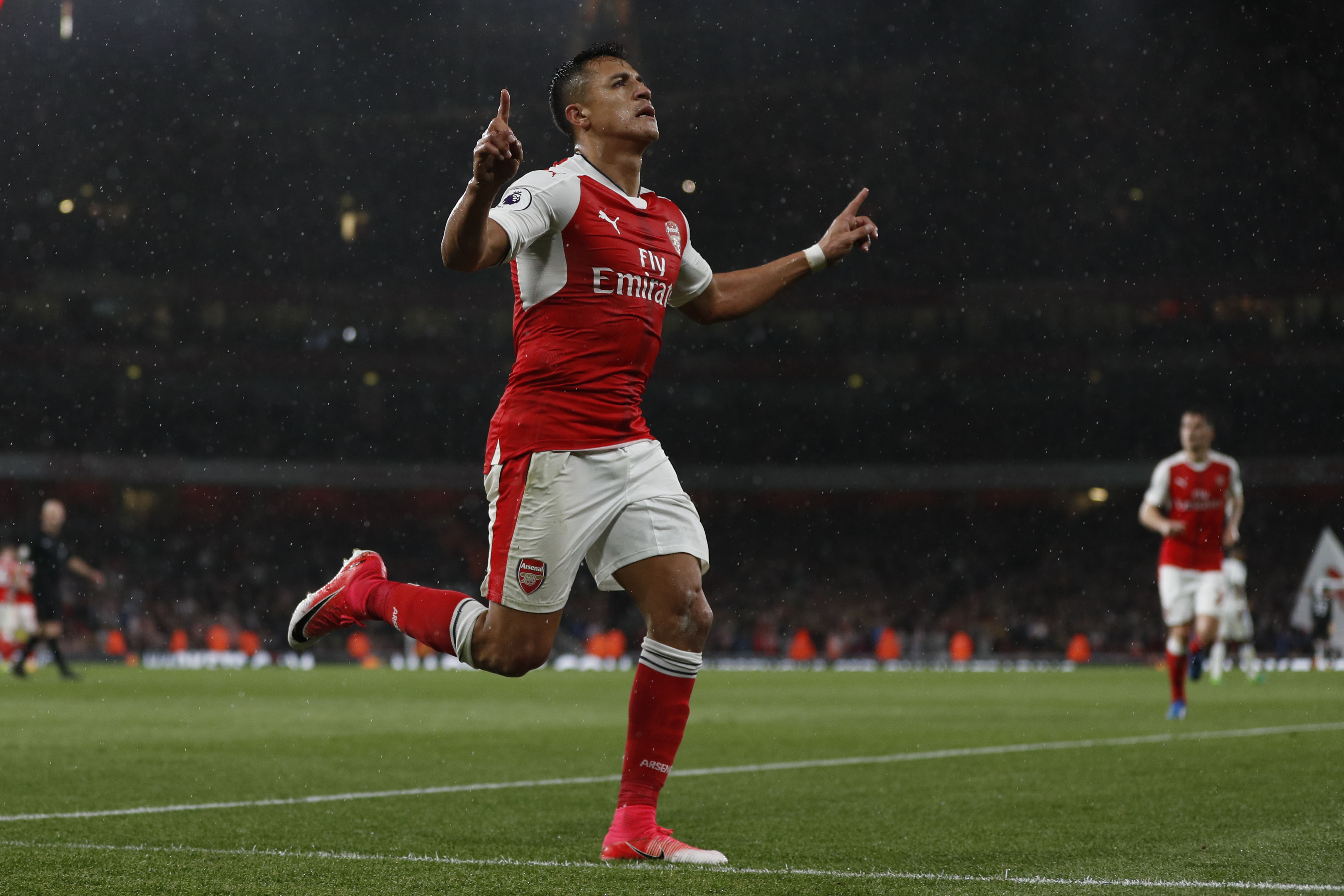 Arsenal's Chilean striker Alexis Sanchez celebrates scoring the second goal during the English Premier League football match between Arsenal and Sunderland at the Emirates Stadium in London on May 16, 2017.  / AFP PHOTO / Adrian DENNIS / RESTRICTED TO EDITORIAL USE. No use with unauthorized audio, video, data, fixture lists, club/league logos or 'live' services. Online in-match use limited to 75 images, no video emulation. No use in betting, games or single club/league/player publications.  /         (Photo credit should read ADRIAN DENNIS/AFP/Getty Images)