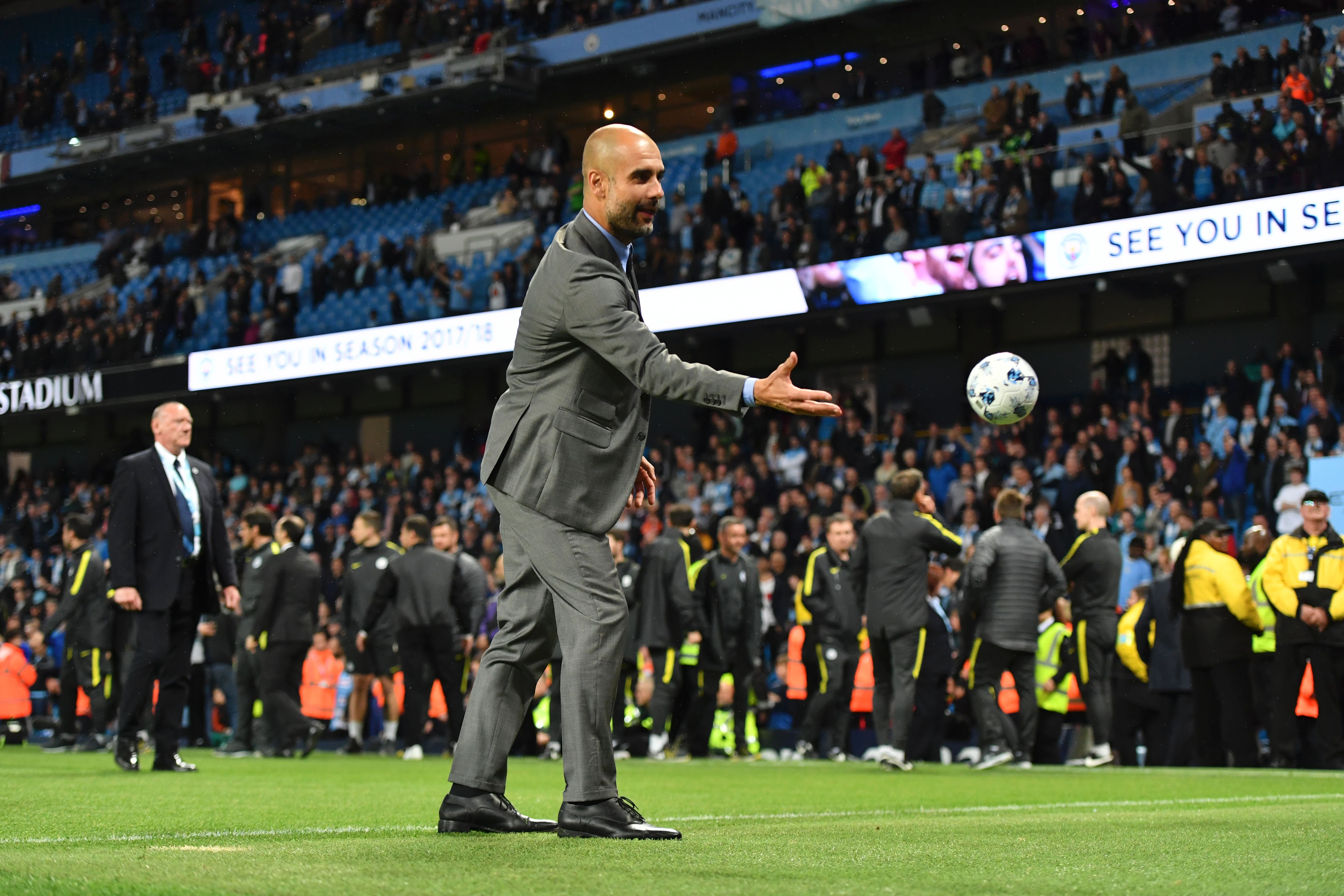 Manchester City's Spanish manager Pep Guardiola plays with a small ball on the pitch at the end of the English Premier League football match between Manchester City and West Bromwich Albion at the Etihad Stadium in Manchester, north west England, on May 16, 2017. / AFP PHOTO / Anthony Devlin / RESTRICTED TO EDITORIAL USE. No use with unauthorized audio, video, data, fixture lists, club/league logos or 'live' services. Online in-match use limited to 75 images, no video emulation. No use in betting, games or single club/league/player publications.  /         (Photo credit should read ANTHONY DEVLIN/AFP/Getty Images)