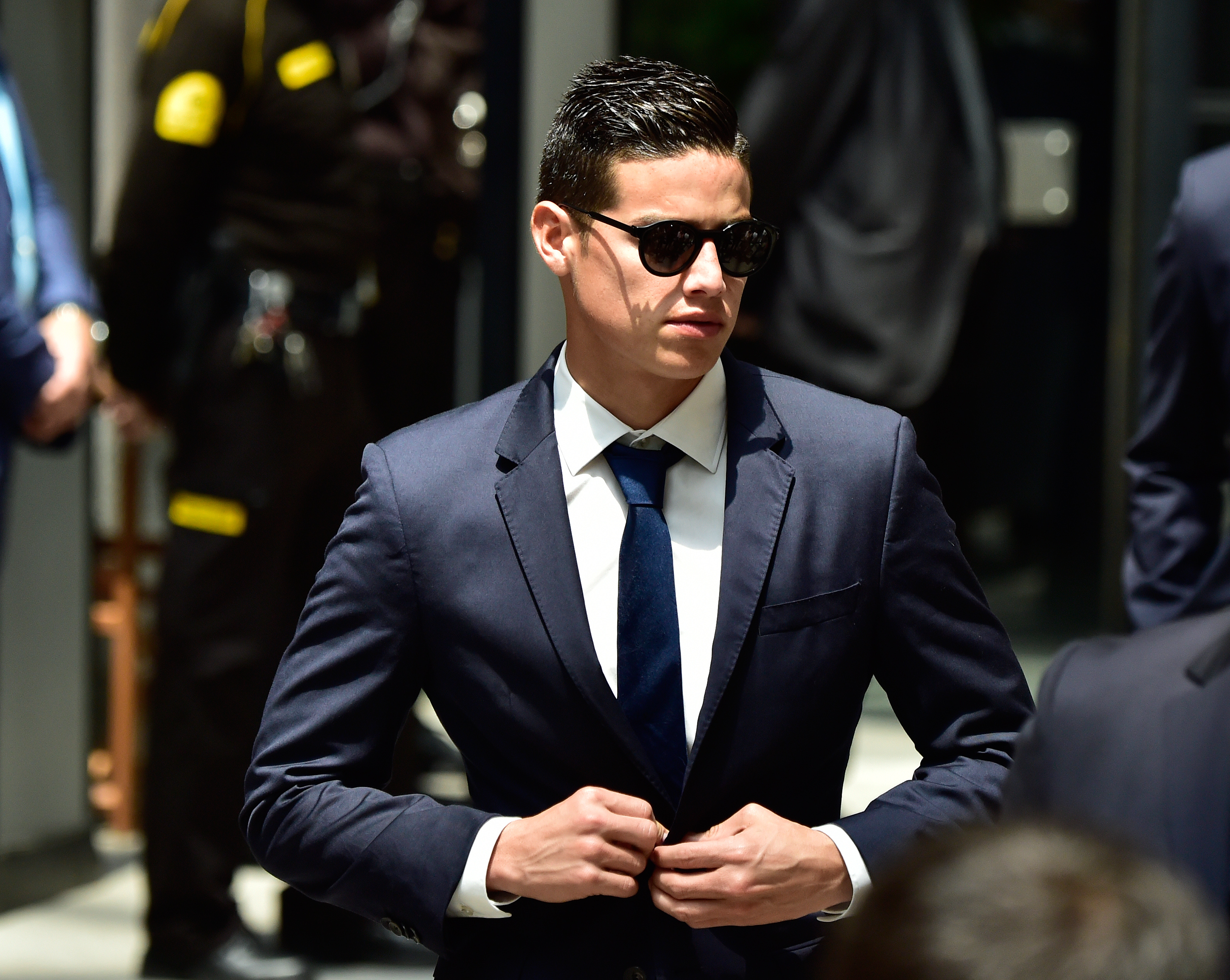 Real Madrid's Colombian midfielder James Rodriguez buttons his jacket as he arrives at the Madrid Town hall on Plaza Cibeles in Madrid on May 22, 2017 during a celeration after the team won the Spanish league football tournament.
Madrid sealed a first La Liga title in five years yesterday -- and 33rd in total -- with a 2-0 victory at Malaga to bring a halt to Barcelona's domination of domestic matters having won six of the previous eight titles.

 / AFP PHOTO / GERARD JULIEN        (Photo credit should read GERARD JULIEN/AFP/Getty Images)