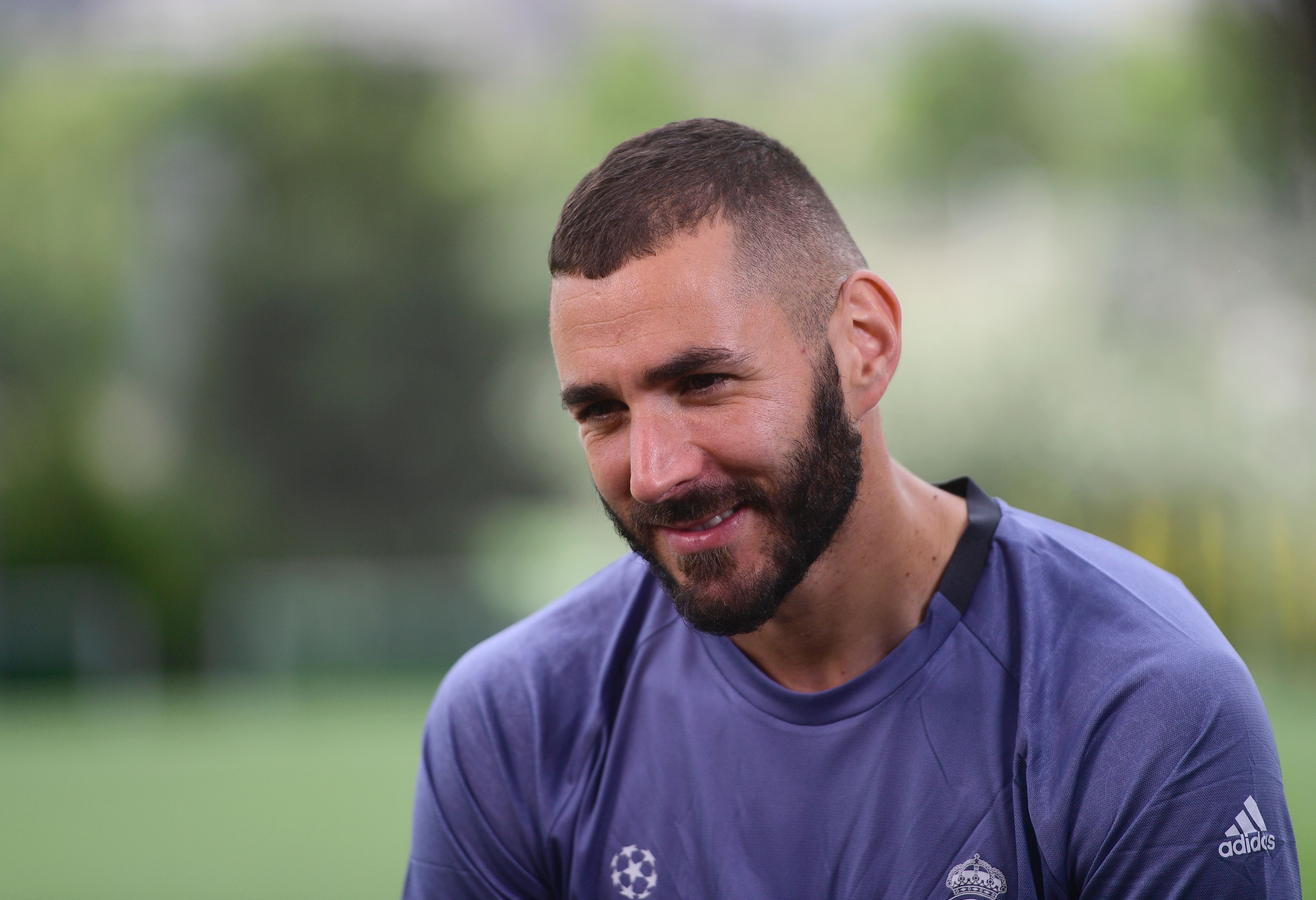 Real Madrid's French forward Karim Benzema attends an interview in the mixed zone at Valdebebas Sport City in Madrid on May 30, 2017 at the Media Day event prior to the UEFA Champions League football match final Juventus vs Real Madrid. / AFP PHOTO / PIERRE-PHILIPPE MARCOU        (Photo credit should read PIERRE-PHILIPPE MARCOU/AFP/Getty Images)