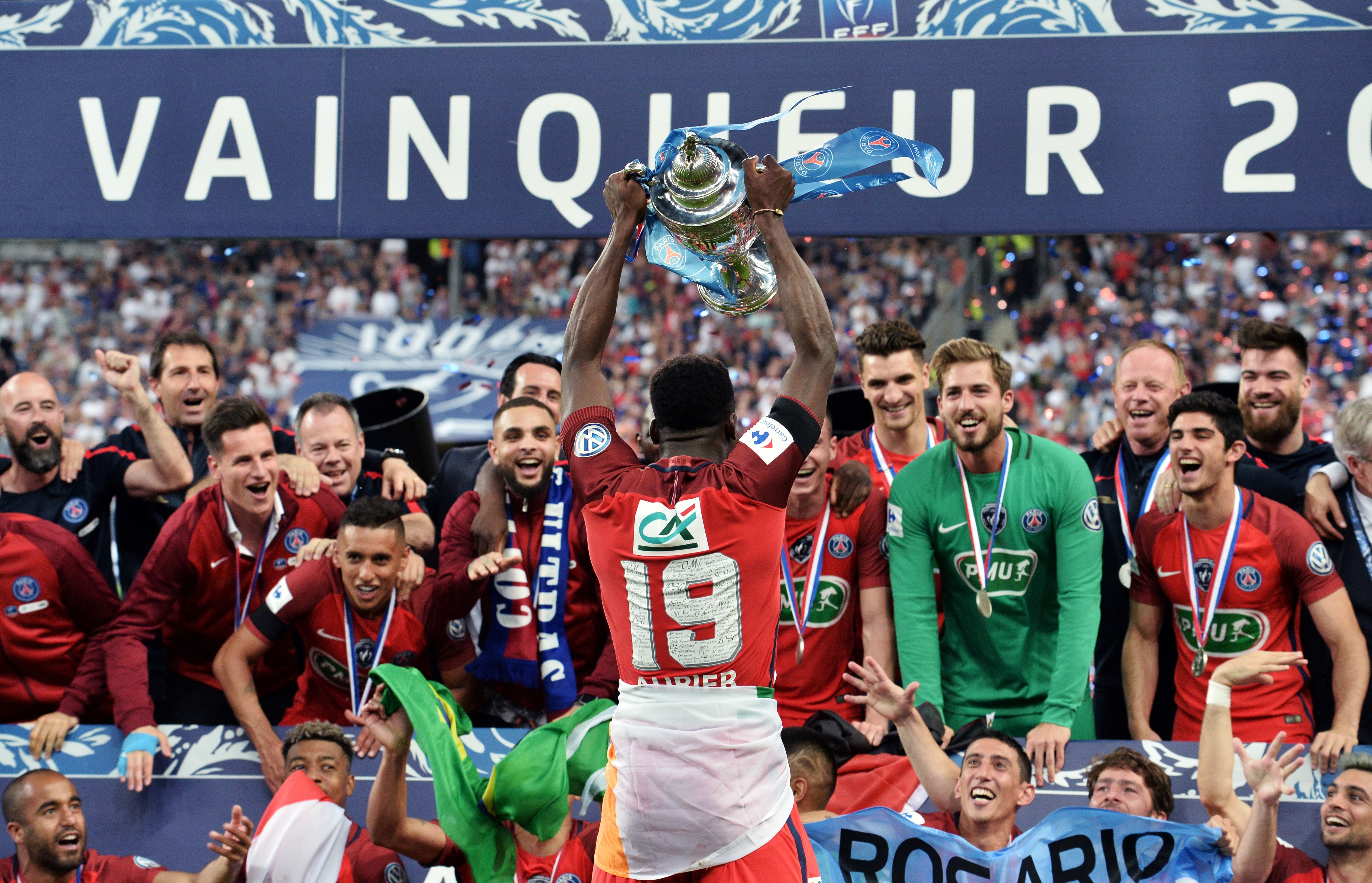 Paris Saint-Germain's Ivorian defender Serge Aurier (C) holds the trophy as he celebrates winning  the French Cup final football match between Paris Saint-Germain (PSG) and Angers (SCO) on May 27, 2017, at the Stade de France in Saint-Denis, north of Paris. / AFP PHOTO / JEAN-FRANCOIS MONIER        (Photo credit should read JEAN-FRANCOIS MONIER/AFP/Getty Images)