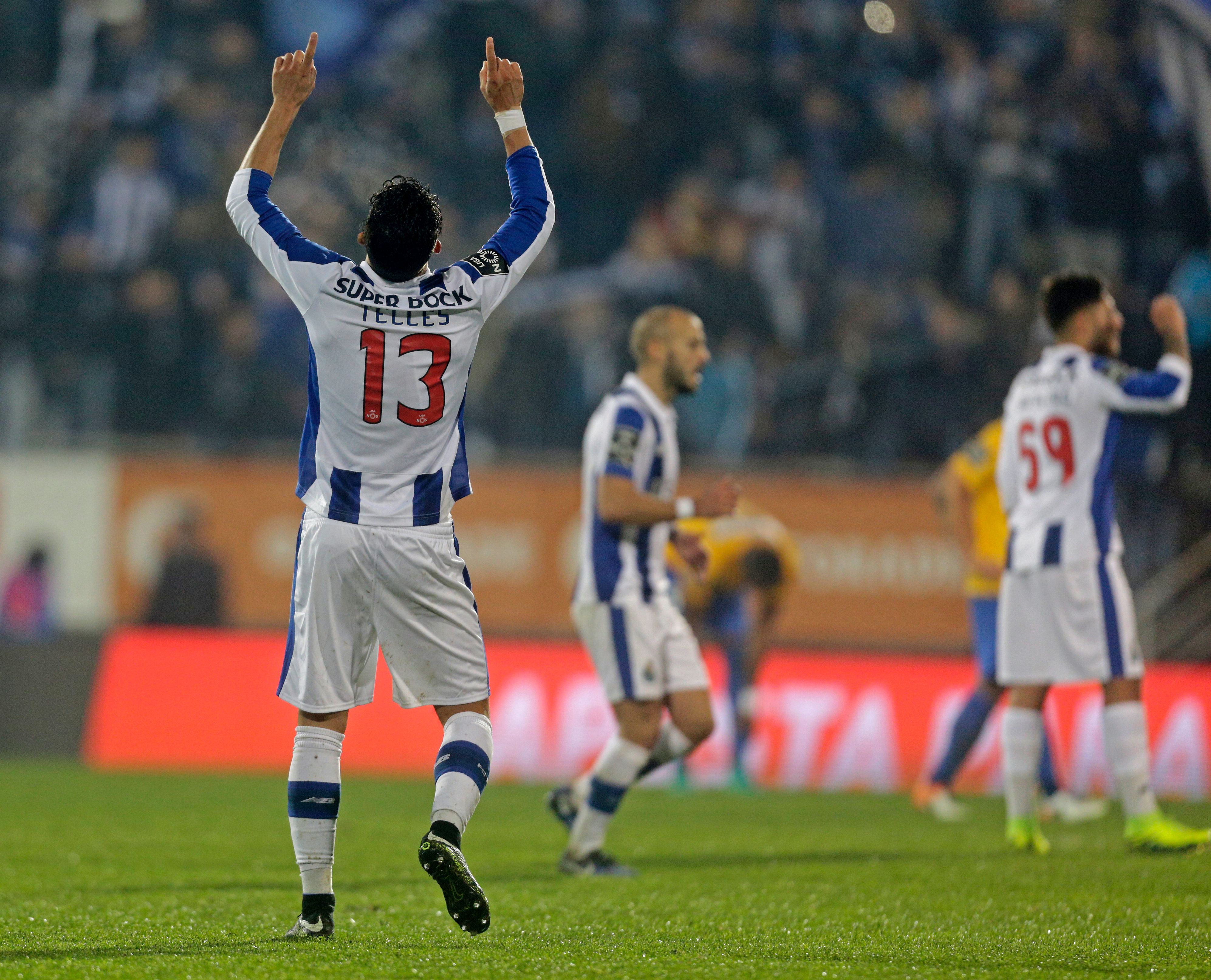 Porto's Brazilian defender Alex Telles (L) celebrates his goal during the Portuguese league football match GD Estoril Praia vs FC Porto at the Antonio Coimbra da Mota stadium in Estoril on January 28, 2017. / AFP / JOSE MANUEL RIBEIRO        (Photo credit should read JOSE MANUEL RIBEIRO/AFP/Getty Images)