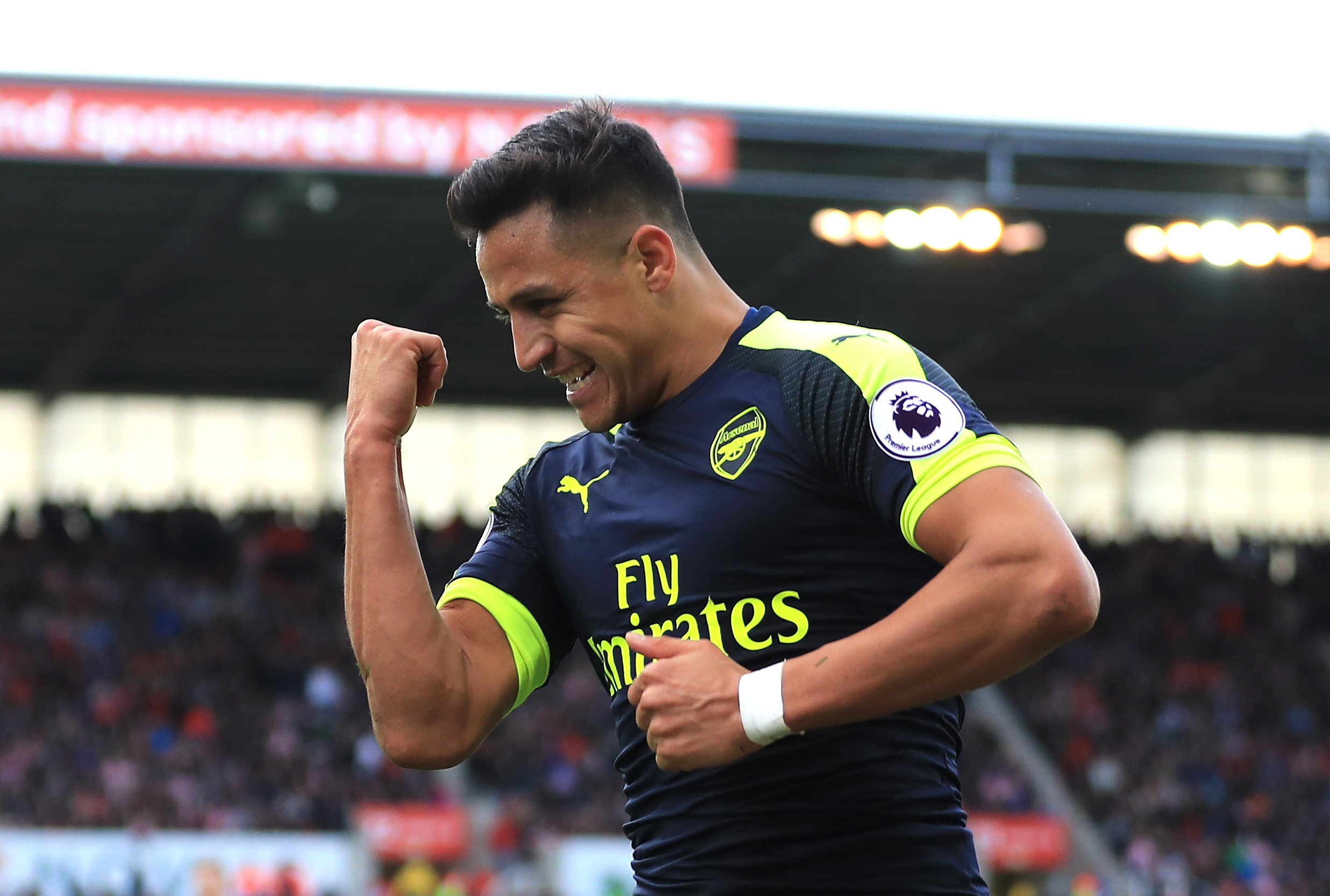 STOKE ON TRENT, ENGLAND - MAY 13:  Alexis Sanchez of Arsenal celebrates scoring his sides third goal during the Premier League match between Stoke City and Arsenal at Bet365 Stadium on May 13, 2017 in Stoke on Trent, England.  (Photo by Richard Heathcote/Getty Images)