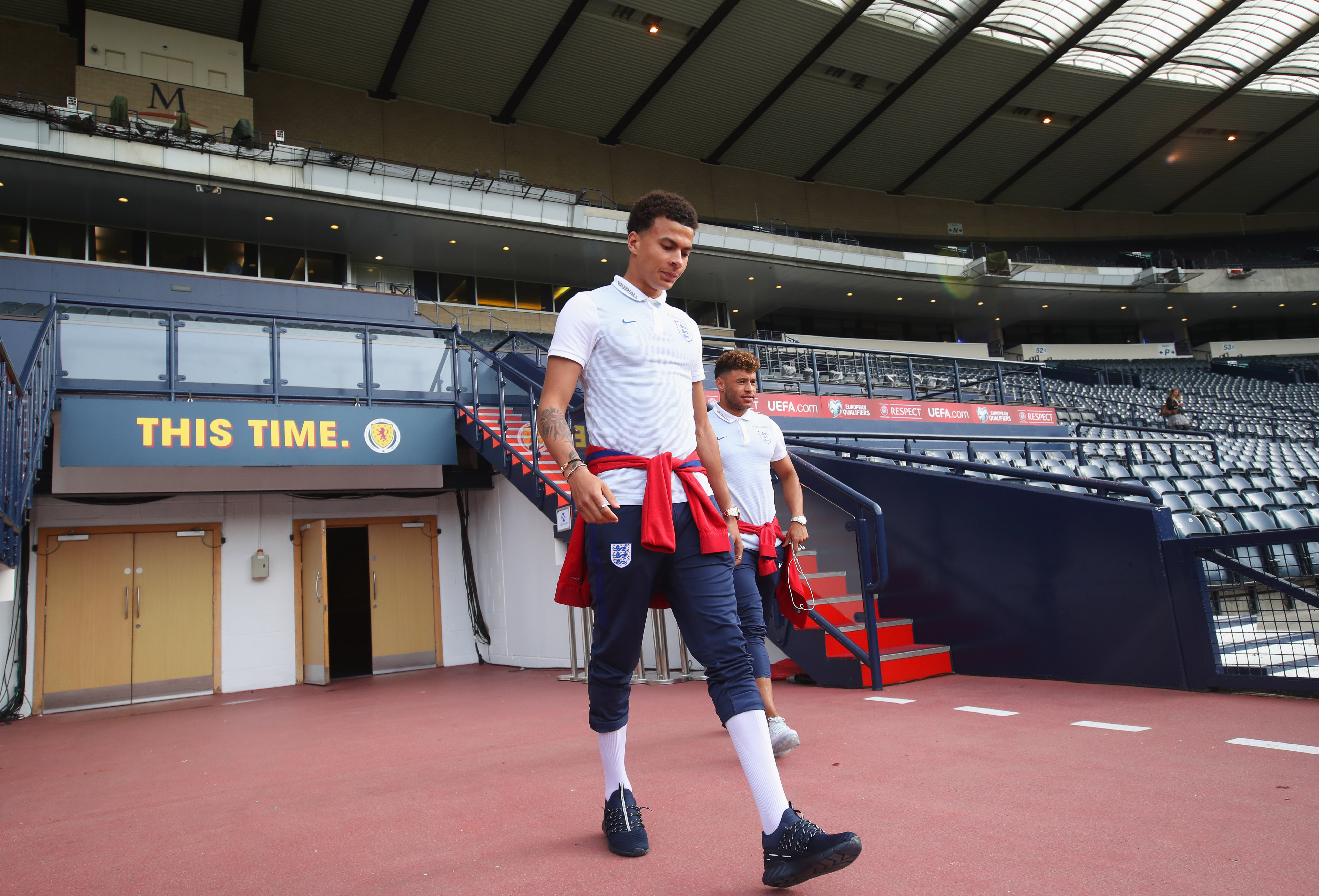 GLASGOW, SCOTLAND - JUNE 09:  Dele Alli of England (front) walks on the pitch with team mate Alex Oxlade-Chamberlain on the eve of their FIFA World Cup qualifier against Scotland at Hampden Park on June 9, 2017 in Glasgow, Scotland.  (Photo by Steve Welsh/Getty Images)