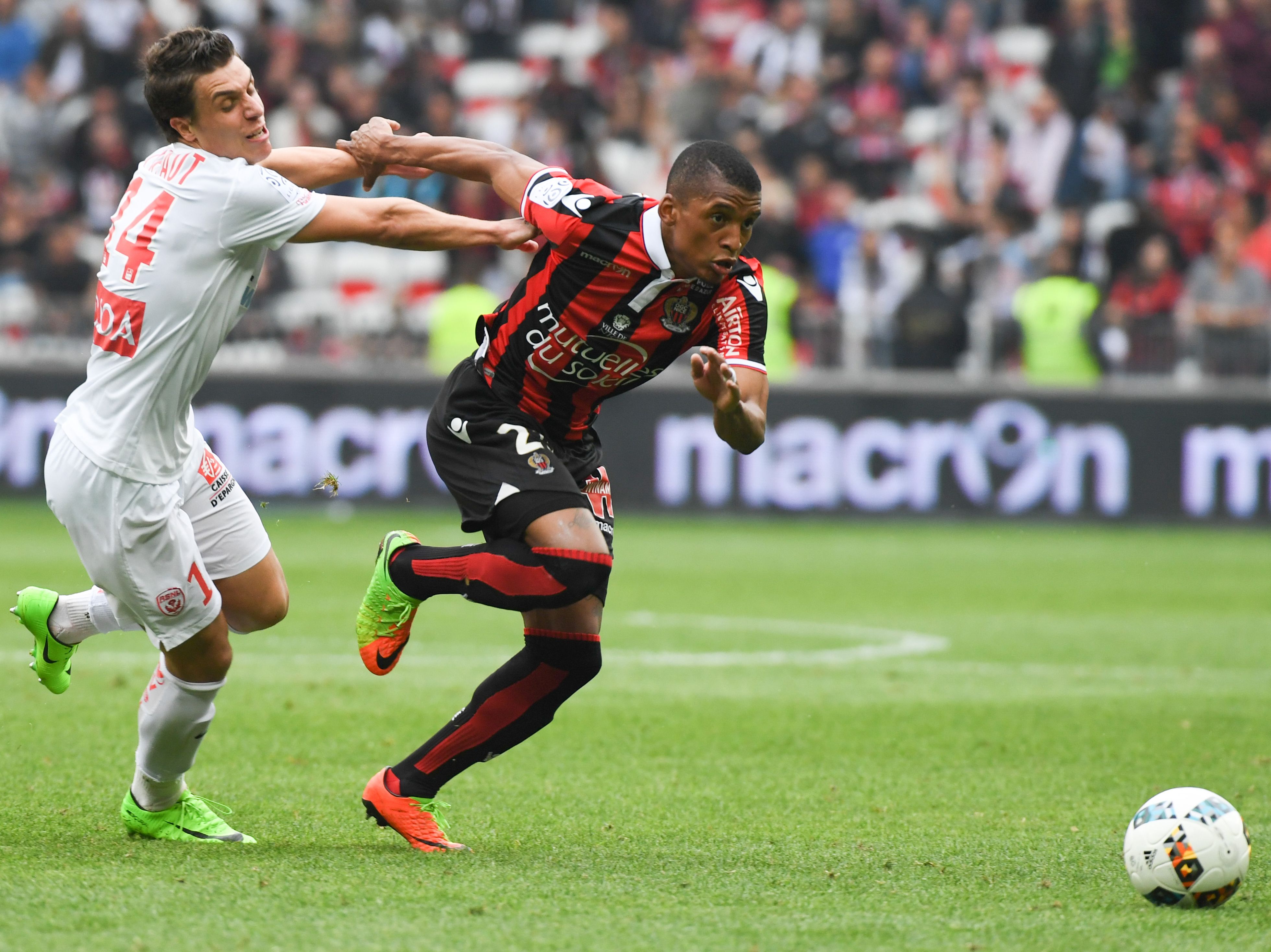 Nice's Brazilian defender Dalbert Henrique (R) runs with the ball as Nancy's French defender Joffrey Cuffaut (L) attempts to block him during the French L1 Football match between OGC Nice and AS Nancy Lorraine at the Allianz Riviera Stadium, in Nice, on April 15, 2017. / AFP PHOTO / Yann COATSALIOU        (Photo credit should read YANN COATSALIOU/AFP/Getty Images)