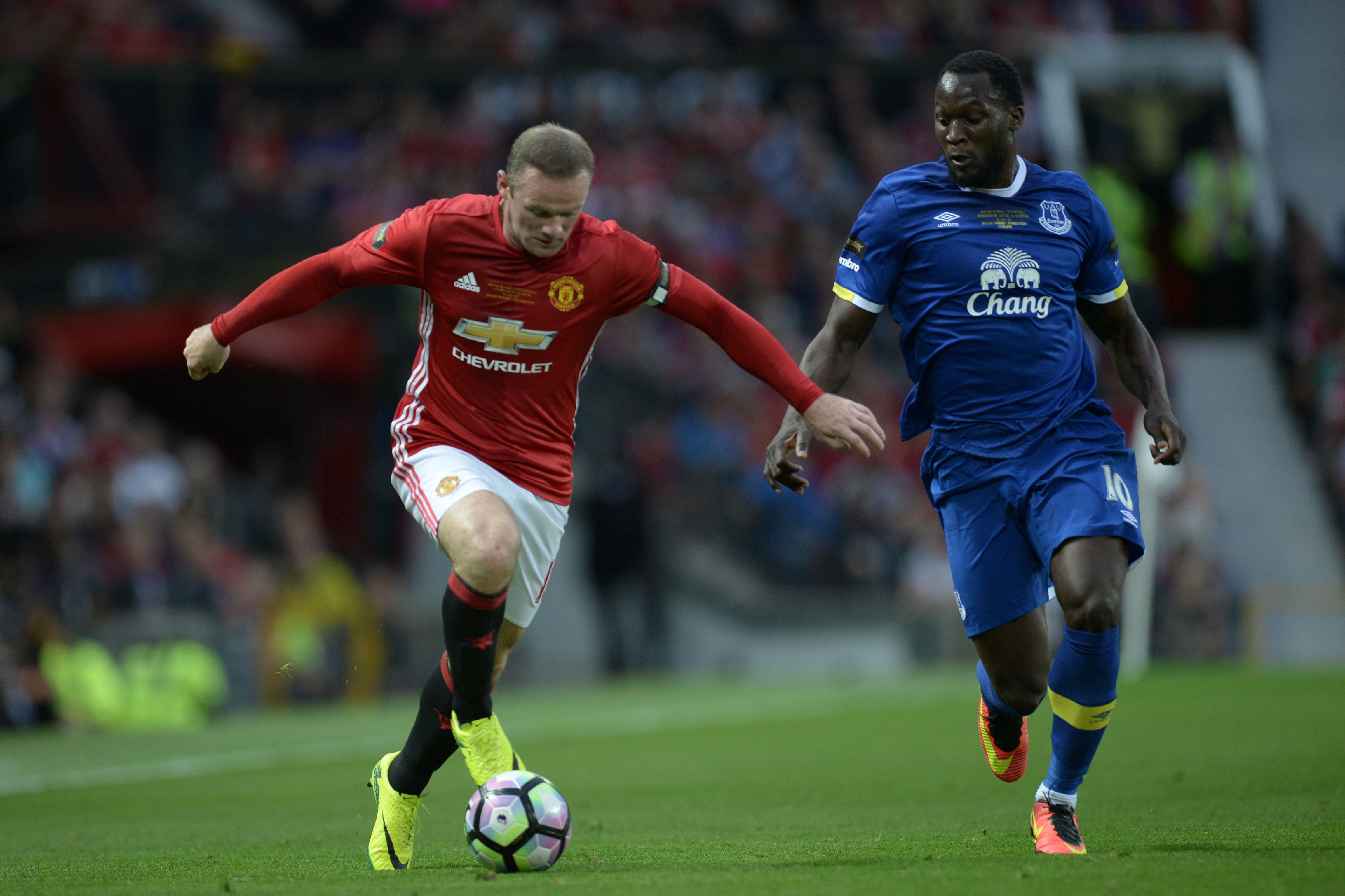 Manchester United's English striker Wayne Rooney (L) runs with the ball challenged by Everton's Belgian striker Romelu Lukaku (R) during the friendly Wayne Rooney testimonial football match between Manchester United and Everton at Old Trafford in Manchester, northwest England, on August 3, 2016.  / AFP / OLI SCARFF        (Photo credit should read OLI SCARFF/AFP/Getty Images)