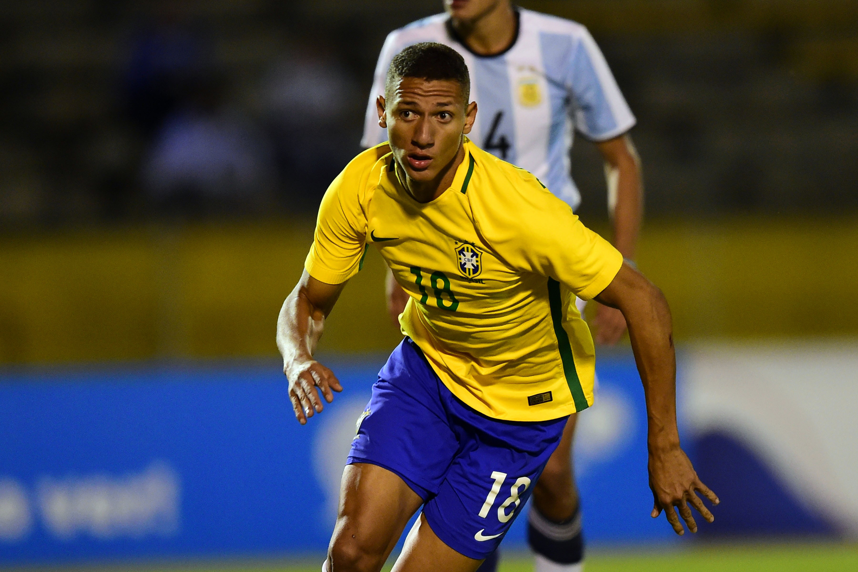 Brazil's player Richarlison (front) celebrates his goal against Argentina during their South American Championship U-20 football match in the Olimpico Atahualpa stadium in Quito on February 8, 2017. / AFP / RODRIGO BUENDIA        (Photo credit should read RODRIGO BUENDIA/AFP/Getty Images)
