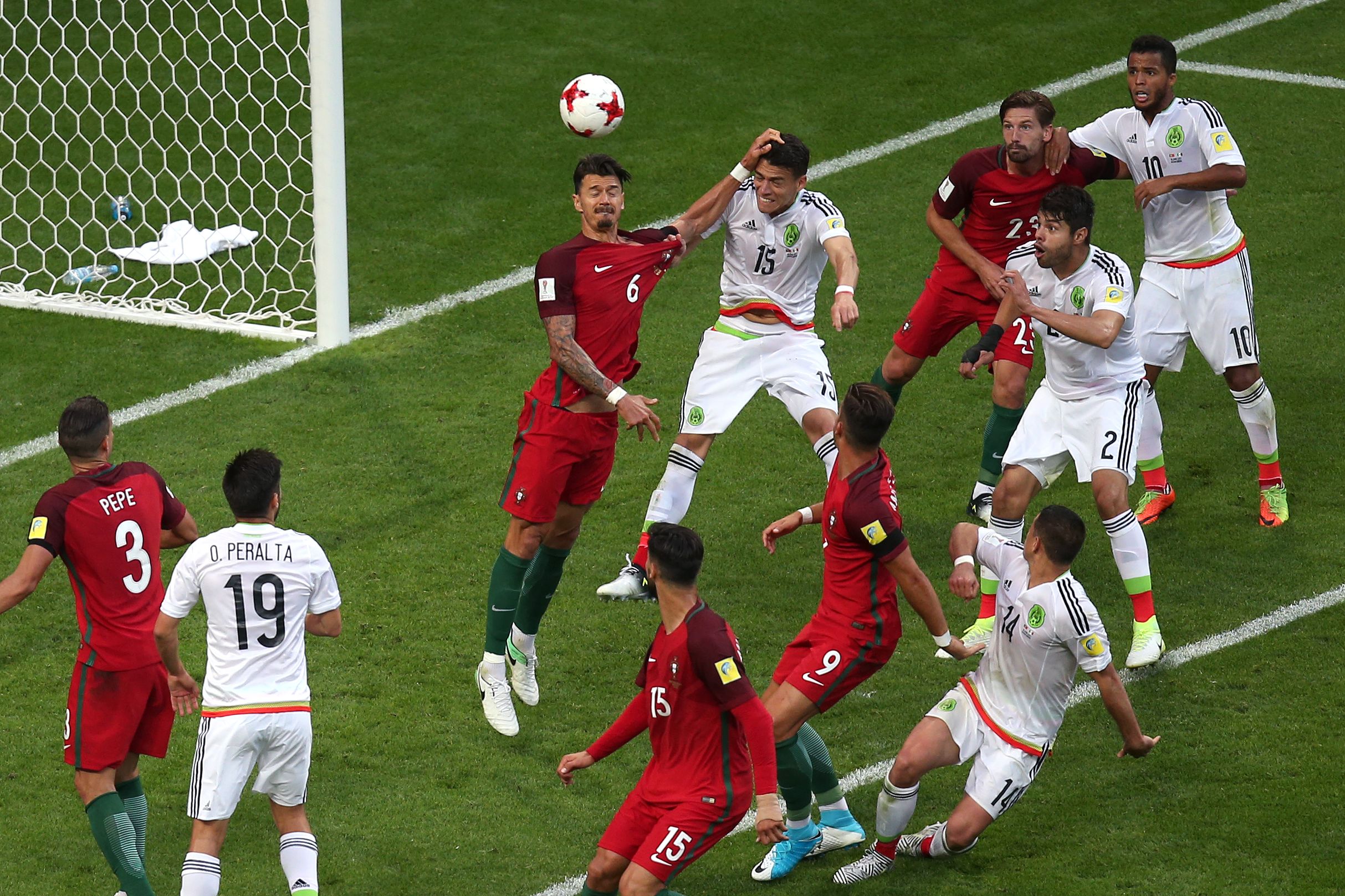 TOPSHOT - Mexico's defender Hector Moreno (C 15) heads the ball to score during the 2017 Confederations Cup group A football match between Portugal and Mexico at the Kazan Arena in Kazan on June 18, 2017. / AFP PHOTO / Roman Kruchinin        (Photo credit should read ROMAN KRUCHININ/AFP/Getty Images)