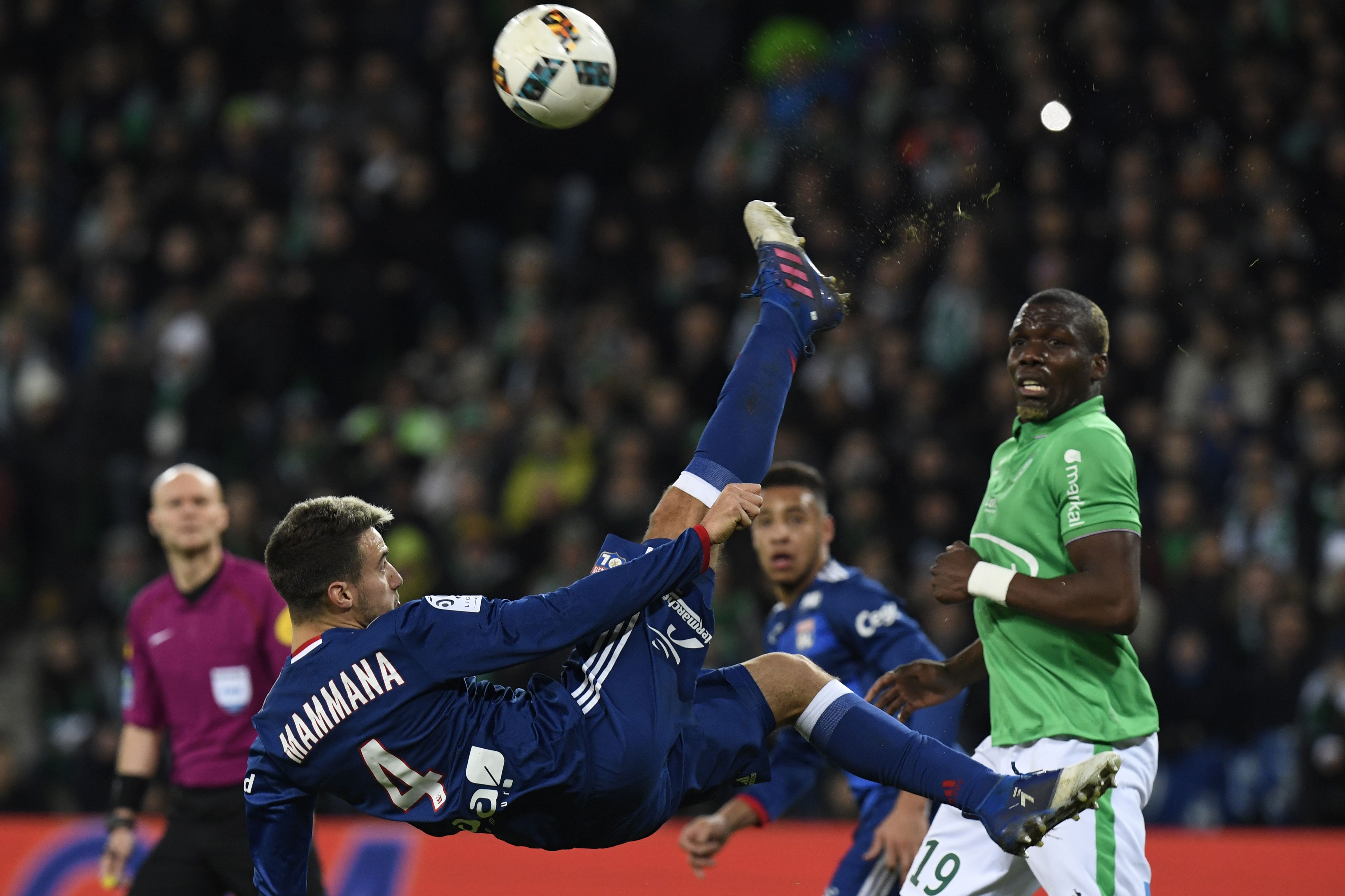 TOPSHOT - Lyon's Argentinian defender Emanuel Mammana kicks the ball as Saint-Etienne's Guinean defender Florentin Pogba (R) looks on during the French L1 football match between AS Saint-Etienne and Olympique Lyonnais on February 5, 2017, at Geoffroy Guichard Stadium in Saint-Etienne. / AFP / PHILIPPE DESMAZES        (Photo credit should read PHILIPPE DESMAZES/AFP/Getty Images)