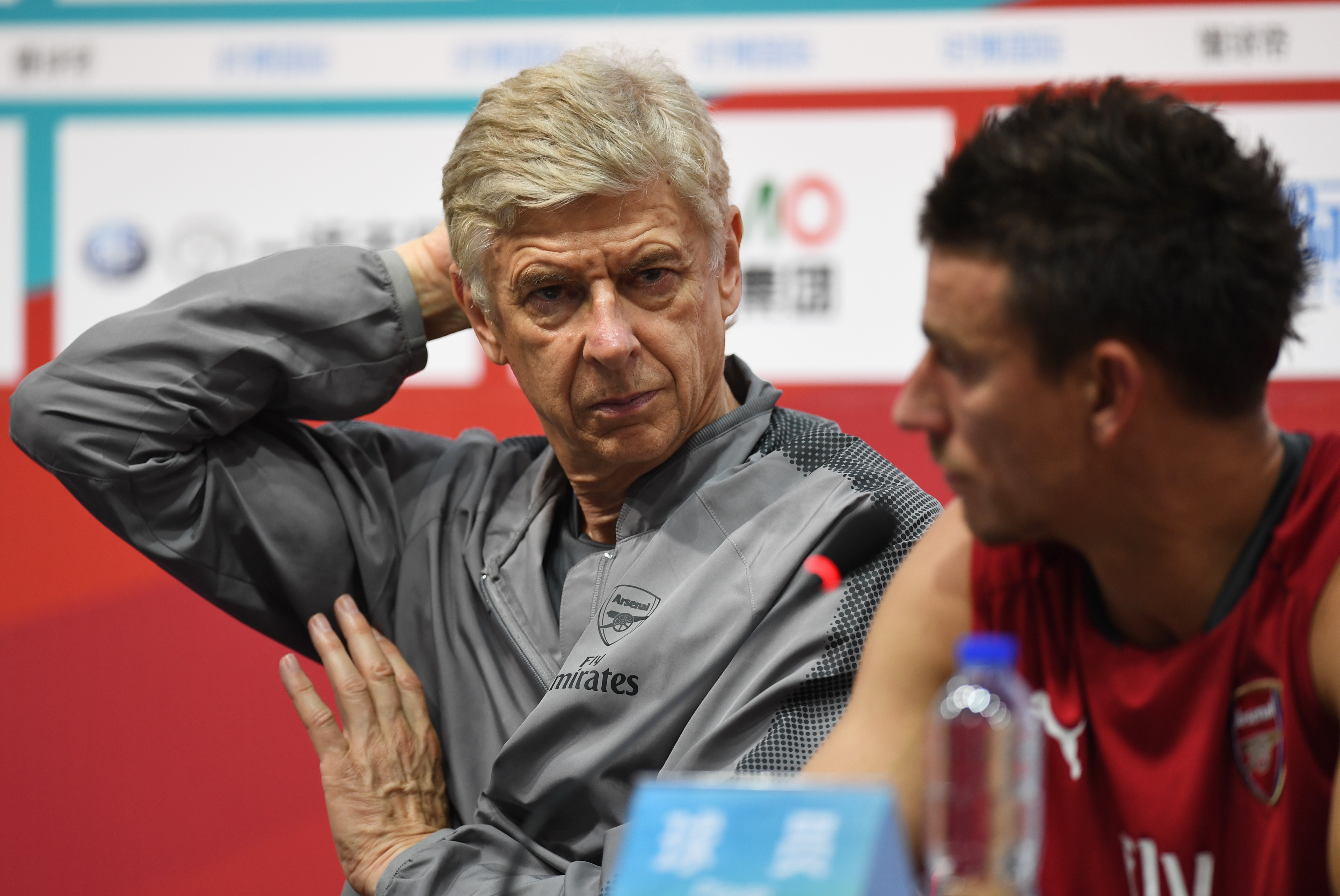 Arsenal coach Arsene Wenger (L) and Laurent Koscielny attend a press conference after a football training session in Beijing's National Stadium, known as the Bird's Nest, on July 21, 2017.
Arsenal will play Chelsea at the Bird's Nest on July 22. / AFP PHOTO / GREG BAKER        (Photo credit should read GREG BAKER/AFP/Getty Images)