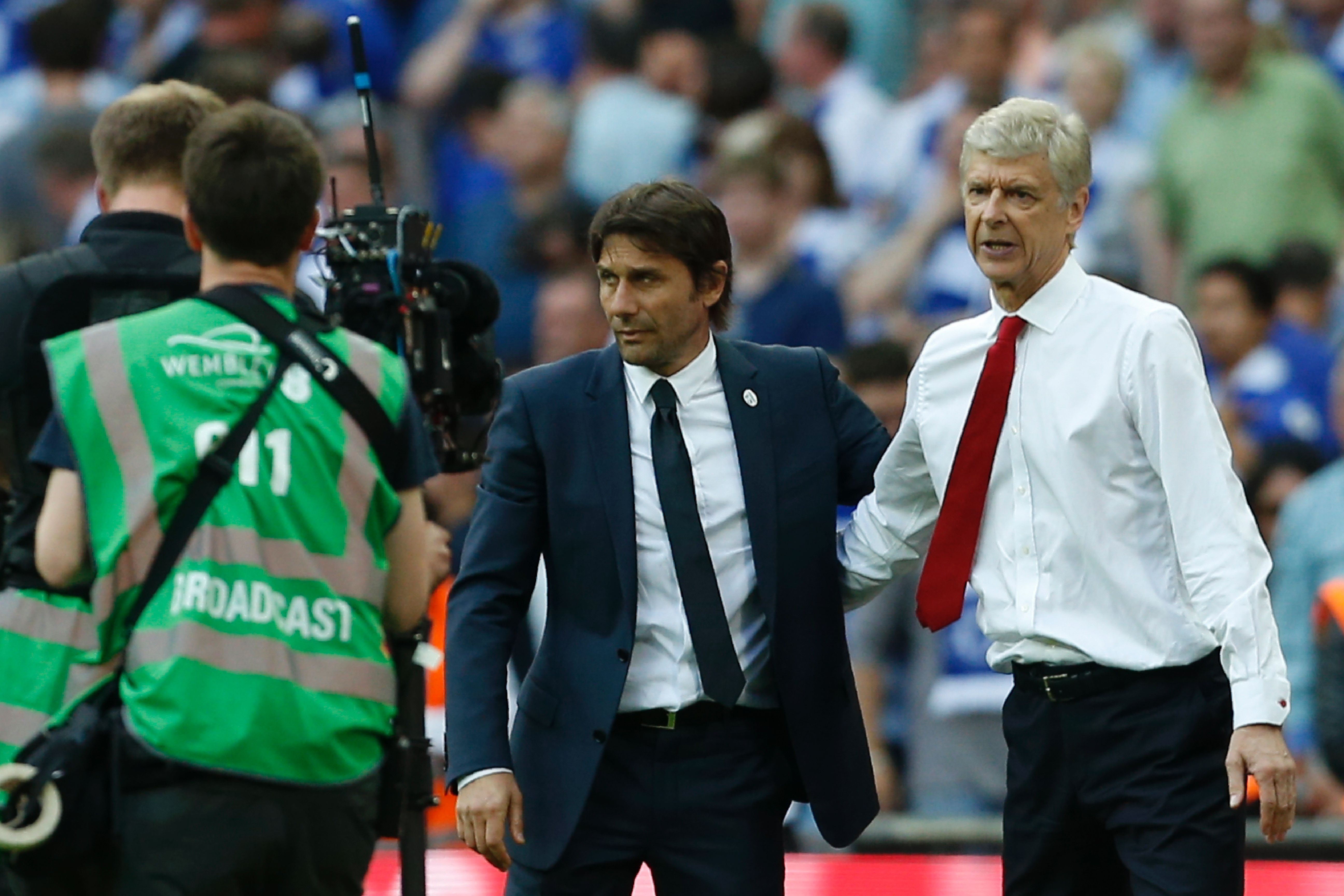 Arsenal's French manager Arsene Wenger (R) and Chelsea's Italian head coach Antonio Conte speak at the final whistle in the English FA Cup final football match between Arsenal and Chelsea at Wembley stadium in London on May 27, 2017.
Aaron Ramsey scored a 79th-minute header to earn Arsenal a stunning 2-1 win over Double-chasing Chelsea on Saturday and deliver embattled manager Arsene Wenger a record seventh FA Cup. / AFP PHOTO / Ian KINGTON / NOT FOR MARKETING OR ADVERTISING USE / RESTRICTED TO EDITORIAL USE        (Photo credit should read IAN KINGTON/AFP/Getty Images)