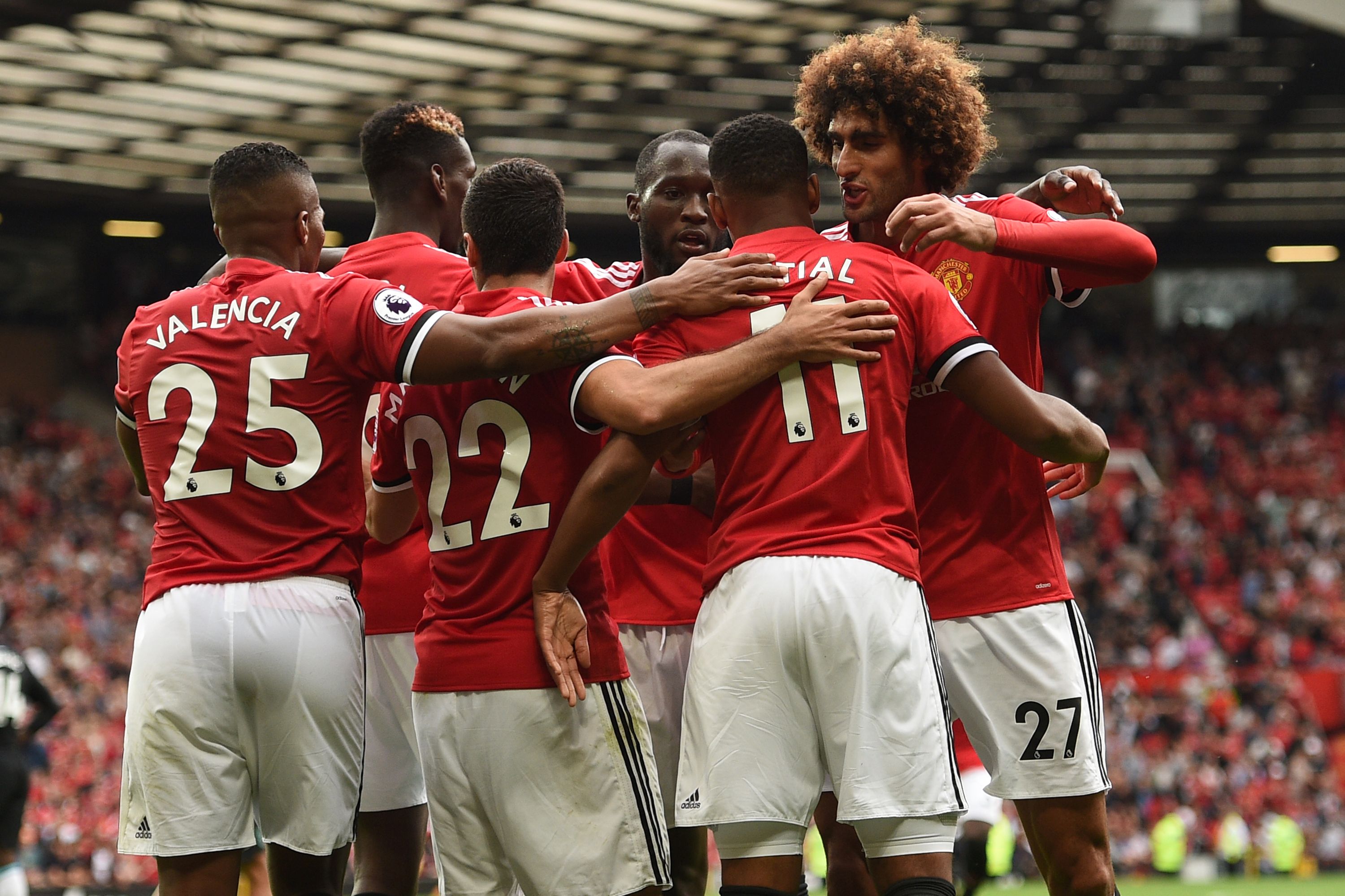 Manchester United's French striker Anthony Martial (2nd R) celebrates with teammates after scoring their third goal during the English Premier League football match between Manchester United and West Ham United at Old Trafford in Manchester, north west England, on August 13, 2017.
Manchester United won the game 4-0. / AFP PHOTO / Oli SCARFF / RESTRICTED TO EDITORIAL USE. No use with unauthorized audio, video, data, fixture lists, club/league logos or 'live' services. Online in-match use limited to 75 images, no video emulation. No use in betting, games or single club/league/player publications.  /         (Photo credit should read OLI SCARFF/AFP/Getty Images)