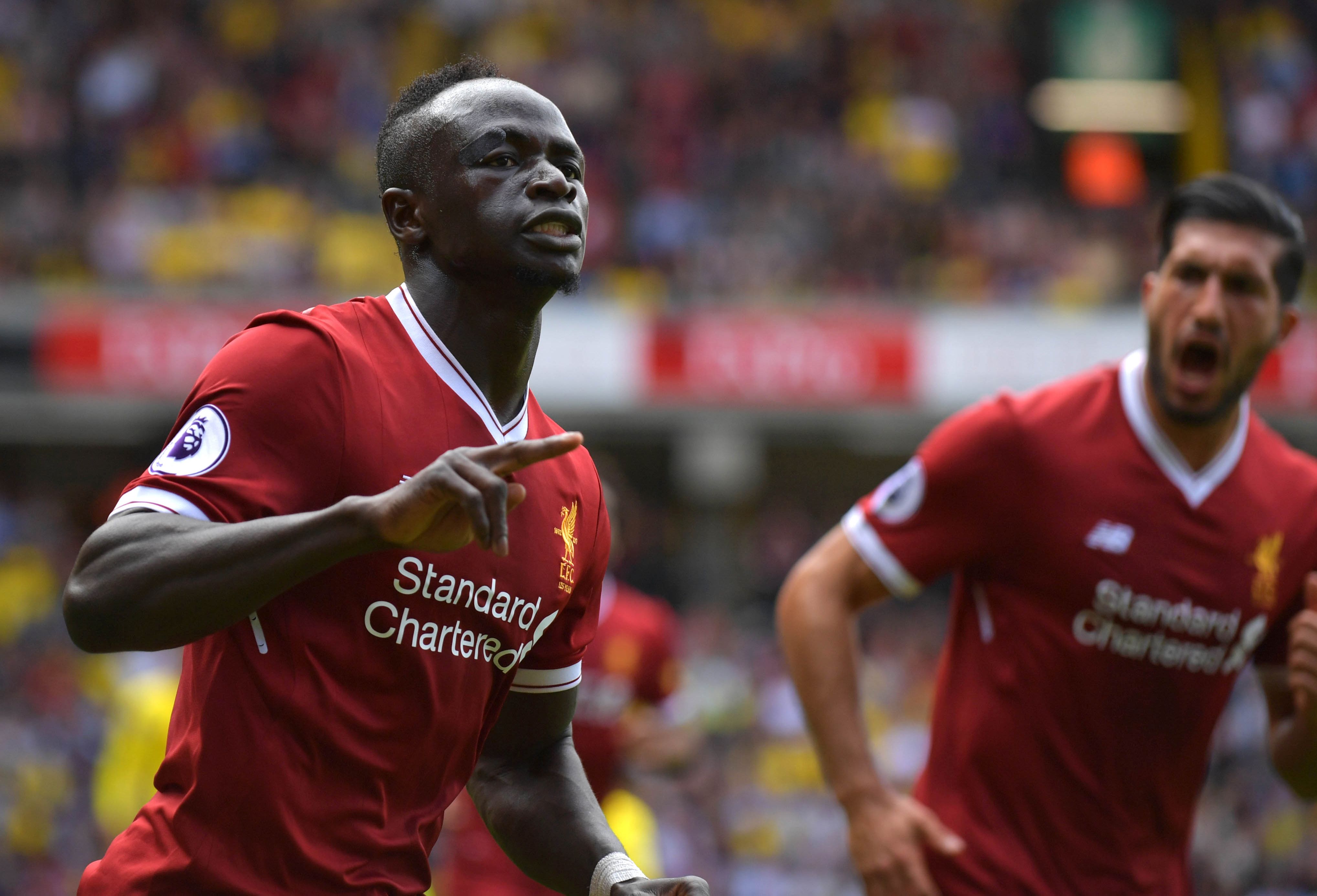 Liverpool's Senegalese midfielder Sadio Mane (l) celebrates scoring his team's second goal during the English Premier League football match between Watford and Liverpool at Vicarage Road Stadium in Watford, north of London on August 12, 2017. / AFP PHOTO / OLLY GREENWOOD / RESTRICTED TO EDITORIAL USE. No use with unauthorized audio, video, data, fixture lists, club/league logos or 'live' services. Online in-match use limited to 75 images, no video emulation. No use in betting, games or single club/league/player publications.  /         (Photo credit should read OLLY GREENWOOD/AFP/Getty Images)