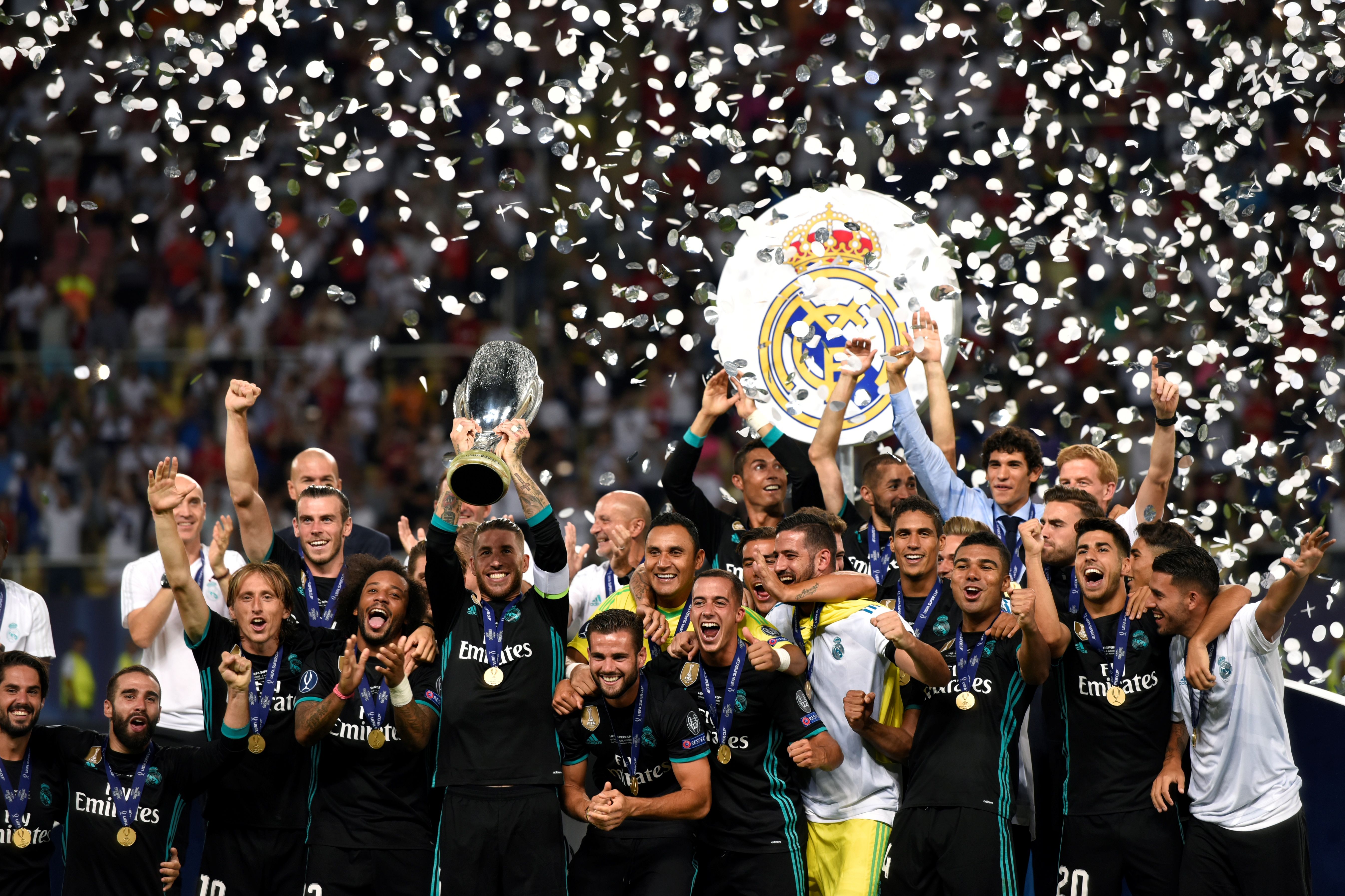 Real Madrid's Spanish defender Sergio Ramos (C) holds the trophy as he celebrates with teammates after winning the UEFA Super Cup final football match between Real Madrid and Manchester United on August 8, 2017, at the Philip II Arena in Skopje. / AFP PHOTO / Dimitar DILKOFF        (Photo credit should read DIMITAR DILKOFF/AFP/Getty Images)