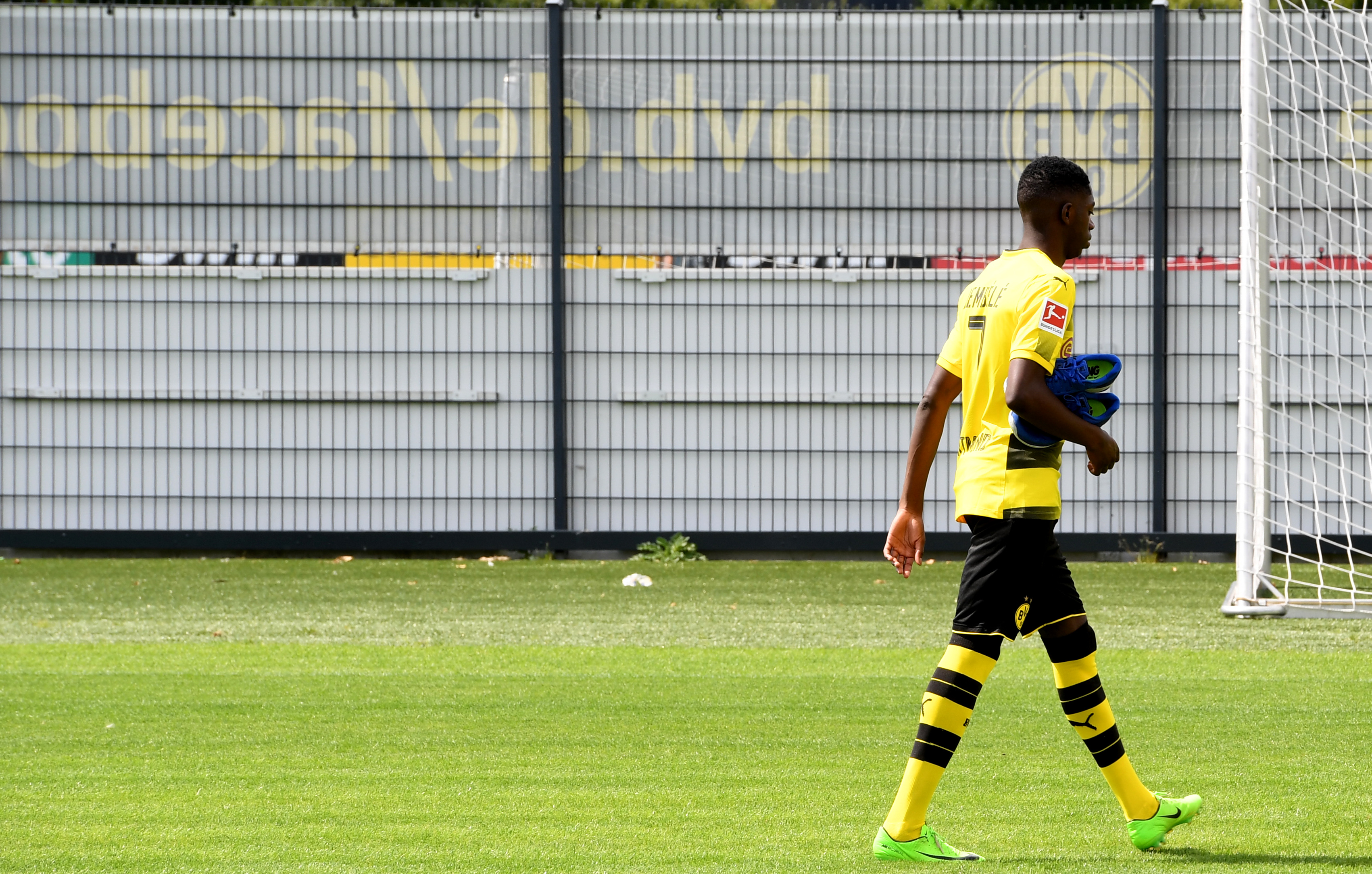 Dortmund's French midfielder Ousmane Dembele walks over the pitch during a press event of German first division Bundesliga football club Borussia Dortmund on August 9, 2017 in Dortmund, western Germany. / AFP PHOTO / PATRIK STOLLARZ        (Photo credit should read PATRIK STOLLARZ/AFP/Getty Images)