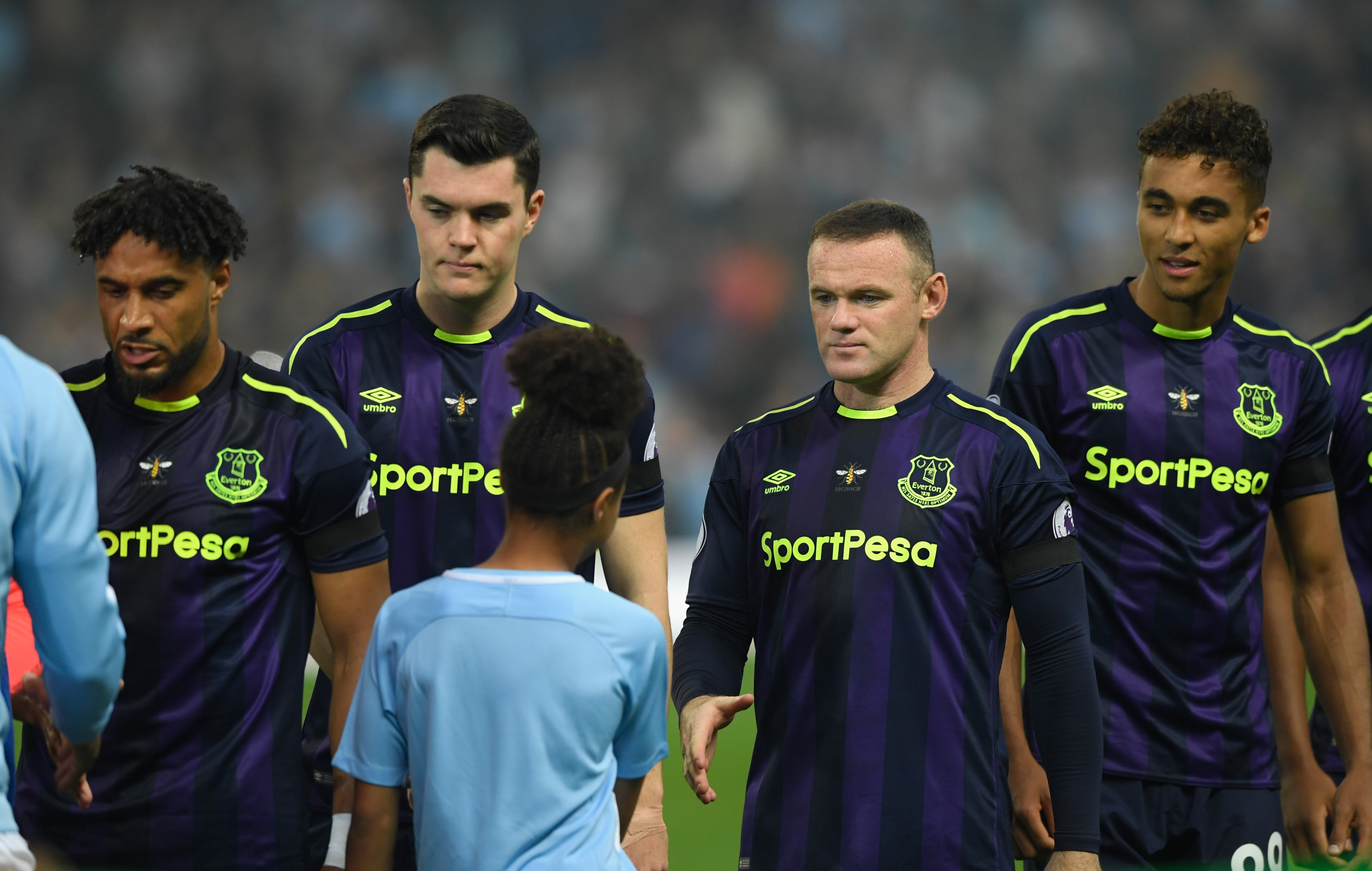 MANCHESTER, ENGLAND - AUGUST 21:  Everton player Wayne Rooney shakes the hand of the mascot before the Premier League match between Manchester City and Everton at Etihad Stadium on August 21, 2017 in Manchester, England.  (Photo by Stu Forster/Getty Images)