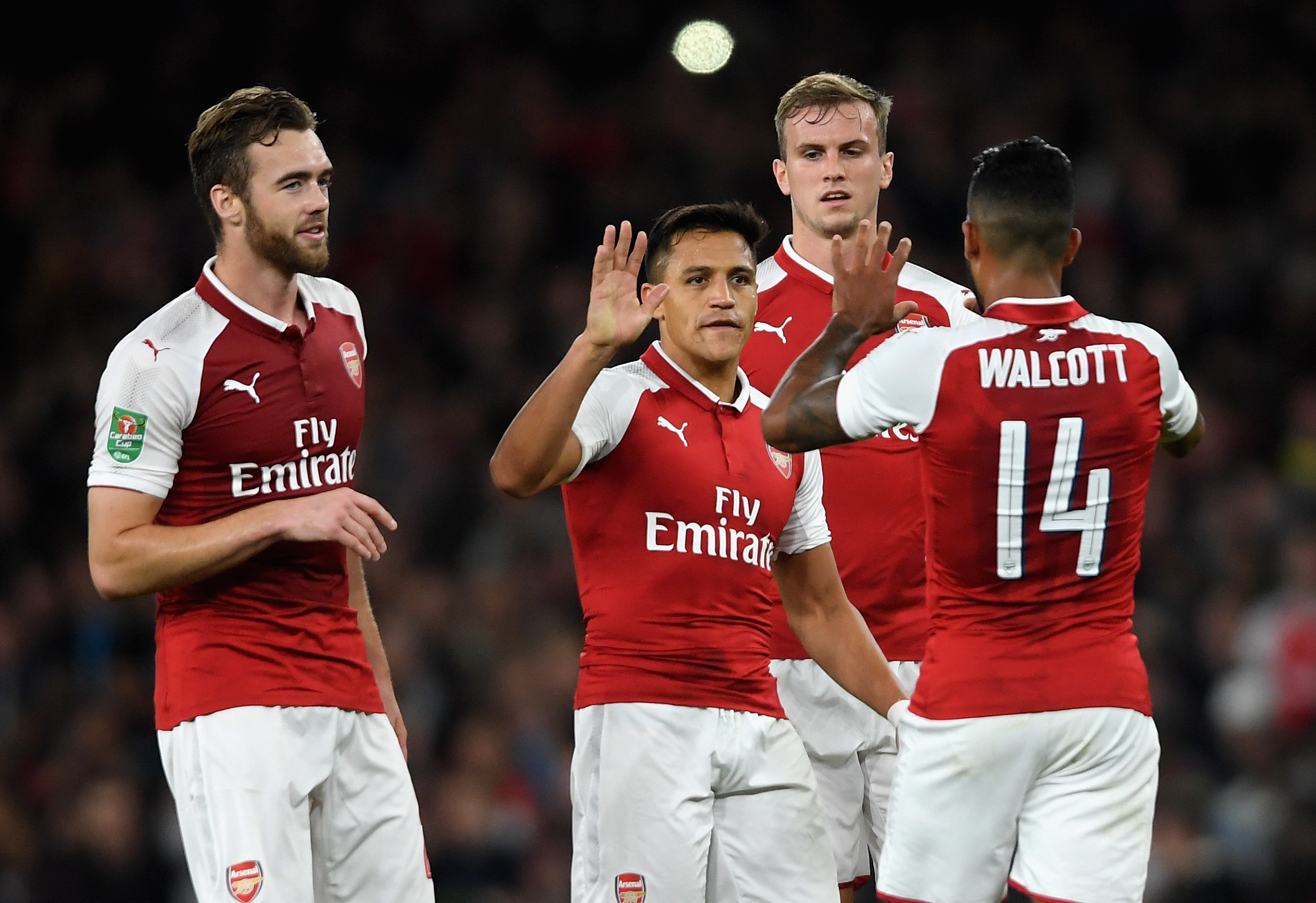 LONDON, ENGLAND - SEPTEMBER 20: Theo Walcott of Arsenal celebrates scoring his sides first goal with his Arsenal team mates during the Carabao Cup Third Round match between Arsenal and Doncaster Rovers at Emirates Stadium on September 20, 2017 in London, England.  (Photo by Mike Hewitt/Getty Images)