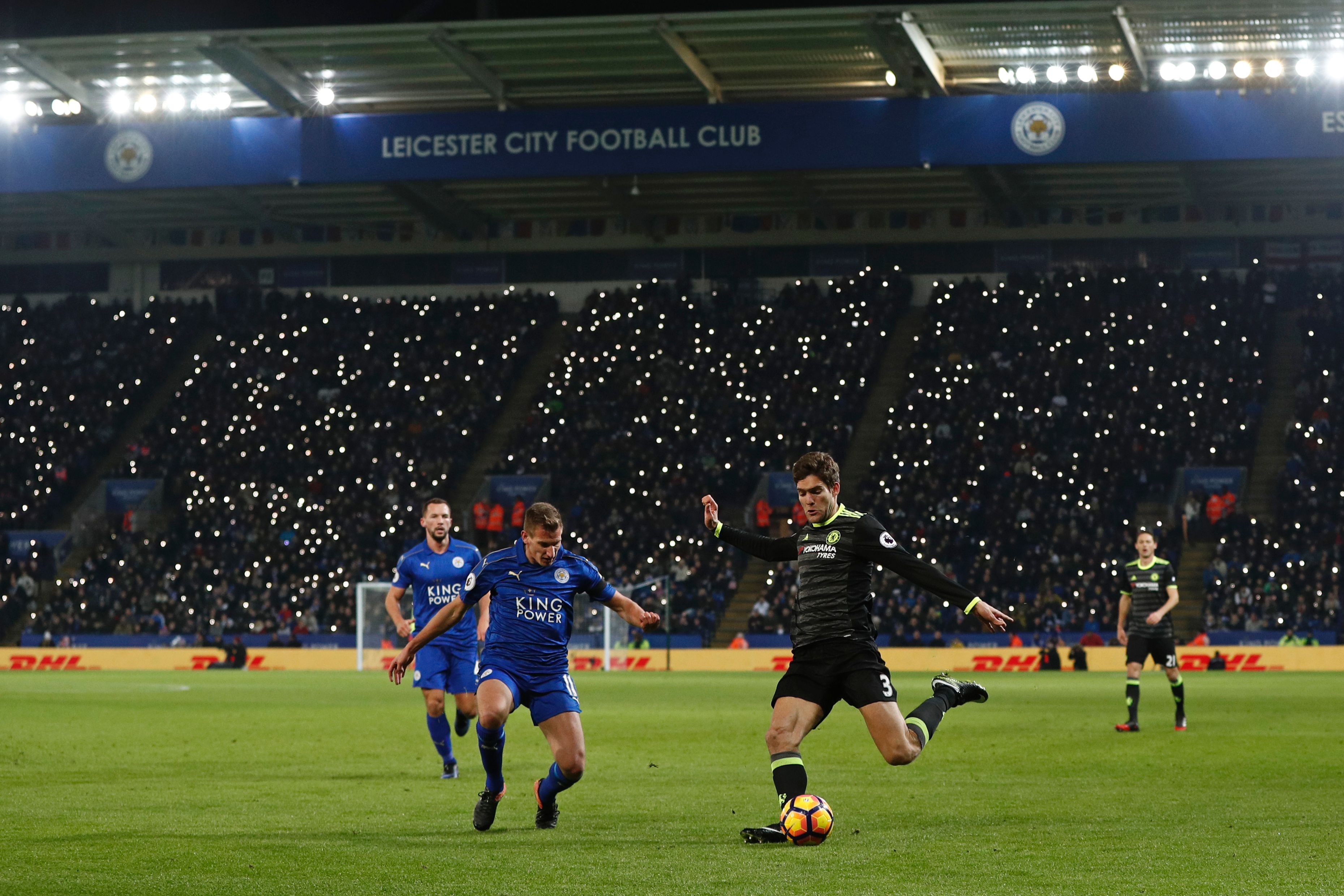 Leicester City's fans shine their mobile phones as lights in support of former player Alan Birchenall, who was taken ill earlier this week, during the English Premier League football match between Leicester City and Chelsea at King Power Stadium in Leicester, central England on January 14, 2017. / AFP / Adrian DENNIS / RESTRICTED TO EDITORIAL USE. No use with unauthorized audio, video, data, fixture lists, club/league logos or 'live' services. Online in-match use limited to 75 images, no video emulation. No use in betting, games or single club/league/player publications.  /         (Photo credit should read ADRIAN DENNIS/AFP/Getty Images)