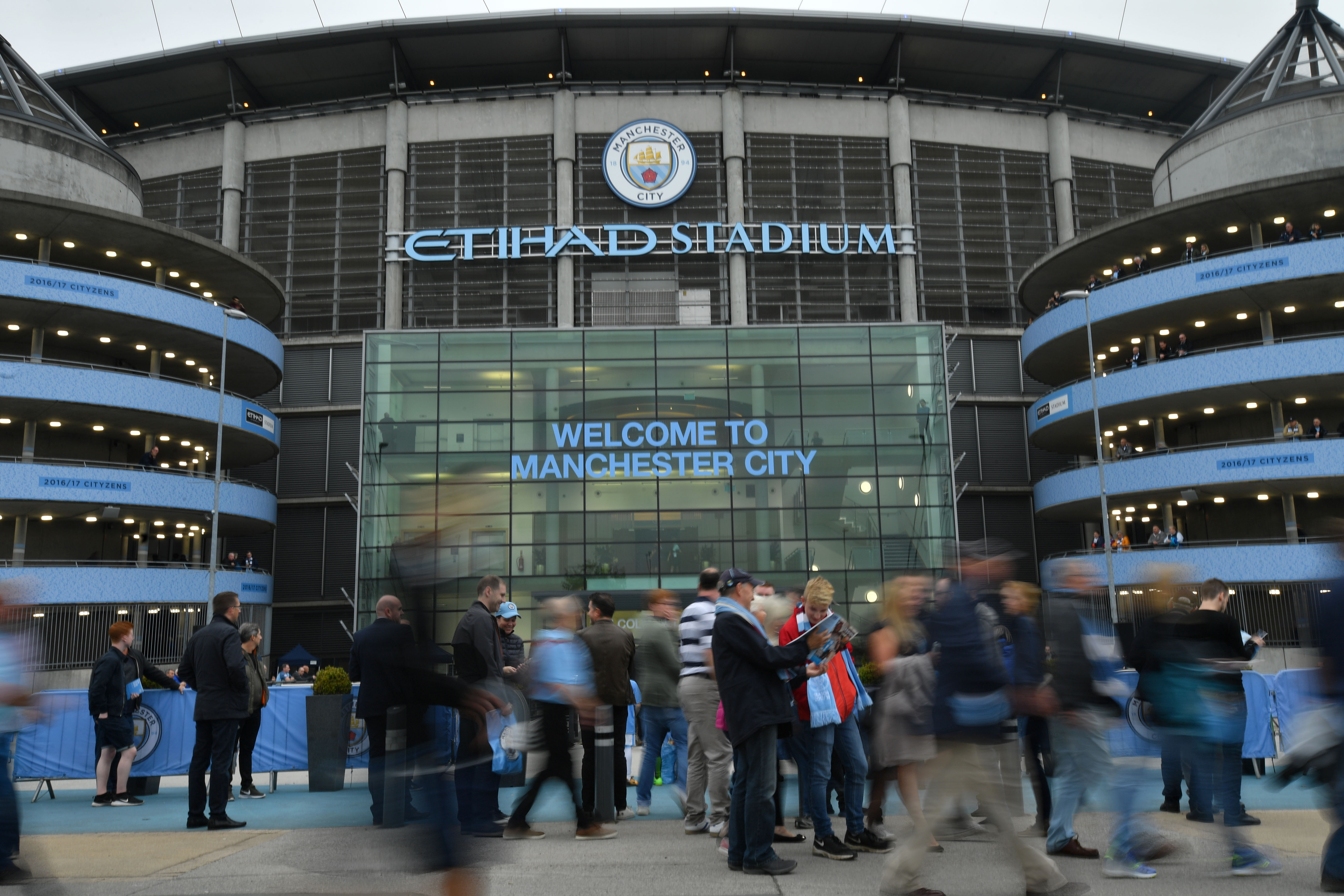 Supporters gather outside the stadium before the English Premier League football match between Manchester City and Everton at the Etihad Stadium in Manchester, north west England, on August 21, 2017. / AFP PHOTO / Anthony DEVLIN / RESTRICTED TO EDITORIAL USE. No use with unauthorized audio, video, data, fixture lists, club/league logos or 'live' services. Online in-match use limited to 75 images, no video emulation. No use in betting, games or single club/league/player publications.  /         (Photo credit should read ANTHONY DEVLIN/AFP/Getty Images)