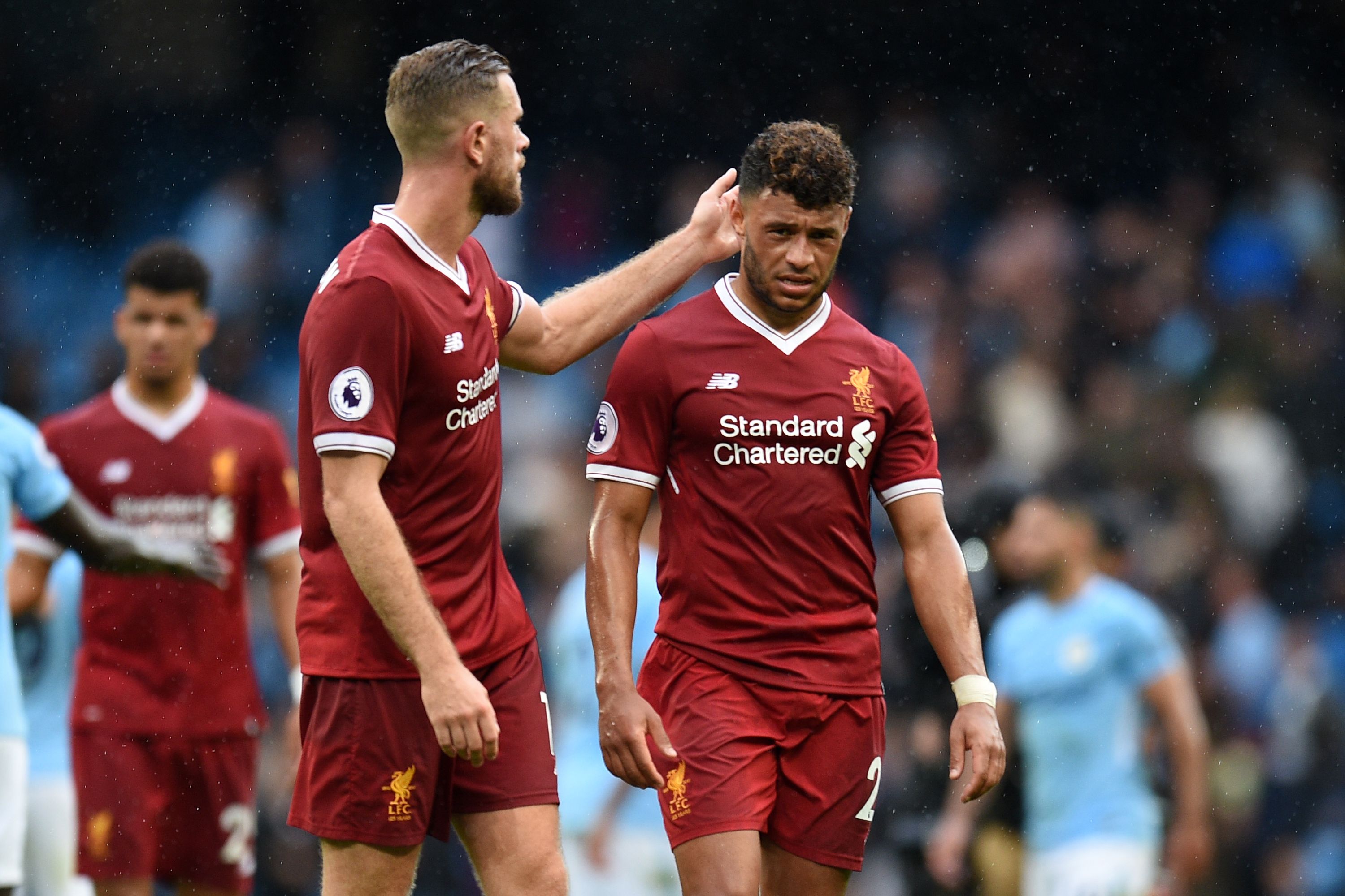 Liverpool's English midfielder Alex Oxlade-Chamberlain (R) reacts with Liverpool's English midfielder Jordan Henderson at the final whistle in the English Premier League football match between Manchester City and Liverpool at the Etihad Stadium in Manchester, north west England, on September 9, 2017.
Manchester City won the game 5-0. / AFP PHOTO / Oli SCARFF / RESTRICTED TO EDITORIAL USE. No use with unauthorized audio, video, data, fixture lists, club/league logos or 'live' services. Online in-match use limited to 75 images, no video emulation. No use in betting, games or single club/league/player publications.  /         (Photo credit should read OLI SCARFF/AFP/Getty Images)