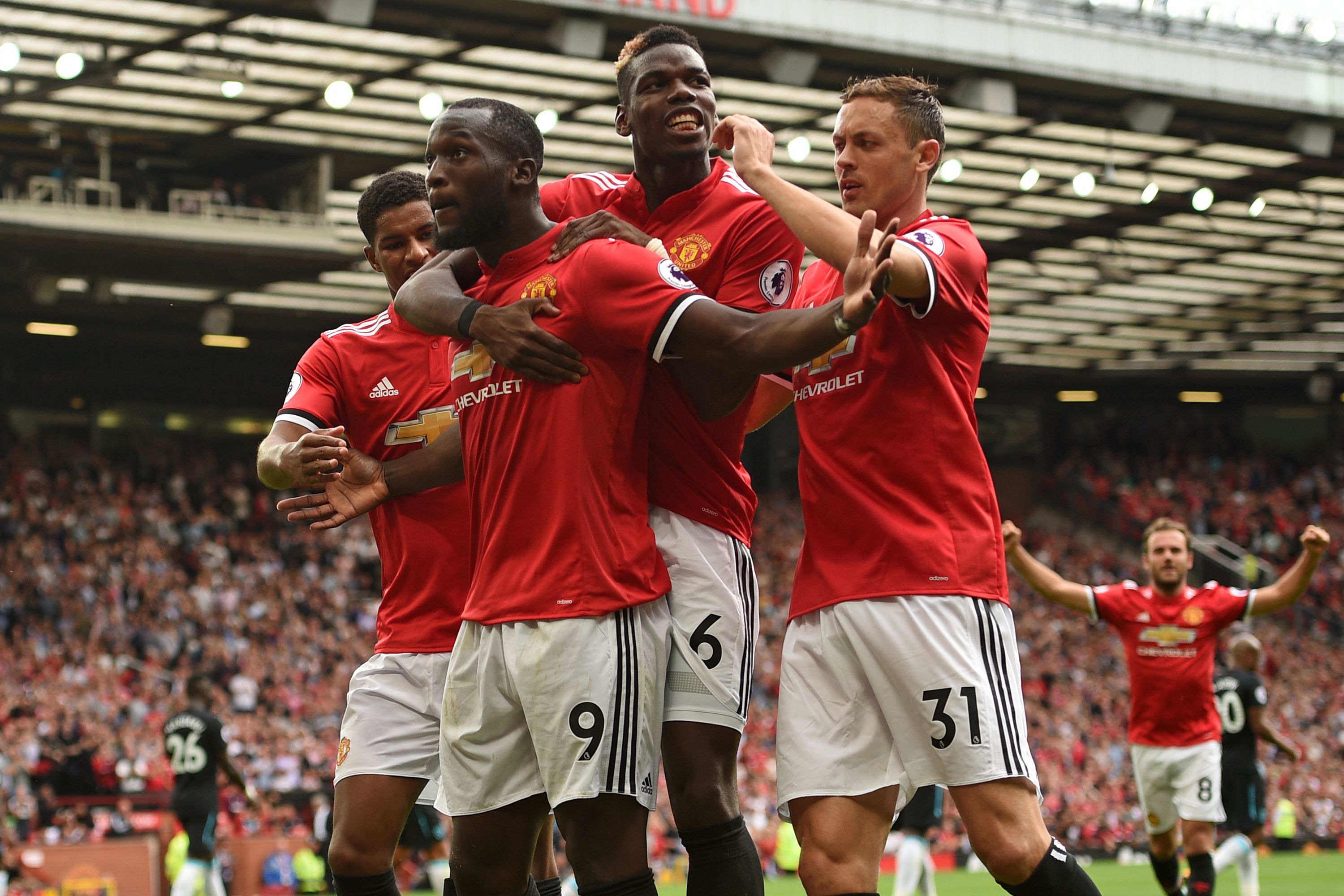 Manchester United's Belgian striker Romelu Lukaku (2L) celebrates scoring his team's second goal with Manchester United's English striker Marcus Rashford (L), Manchester United's French midfielder Paul Pogba (2R) and Manchester United's Serbian midfielder Nemanja Matic during the English Premier League football match between Manchester United and West Ham United at Old Trafford in Manchester, north west England, on August 13, 2017. / AFP PHOTO / Oli SCARFF / RESTRICTED TO EDITORIAL USE. No use with unauthorized audio, video, data, fixture lists, club/league logos or 'live' services. Online in-match use limited to 75 images, no video emulation. No use in betting, games or single club/league/player publications.  /         (Photo credit should read OLI SCARFF/AFP/Getty Images)