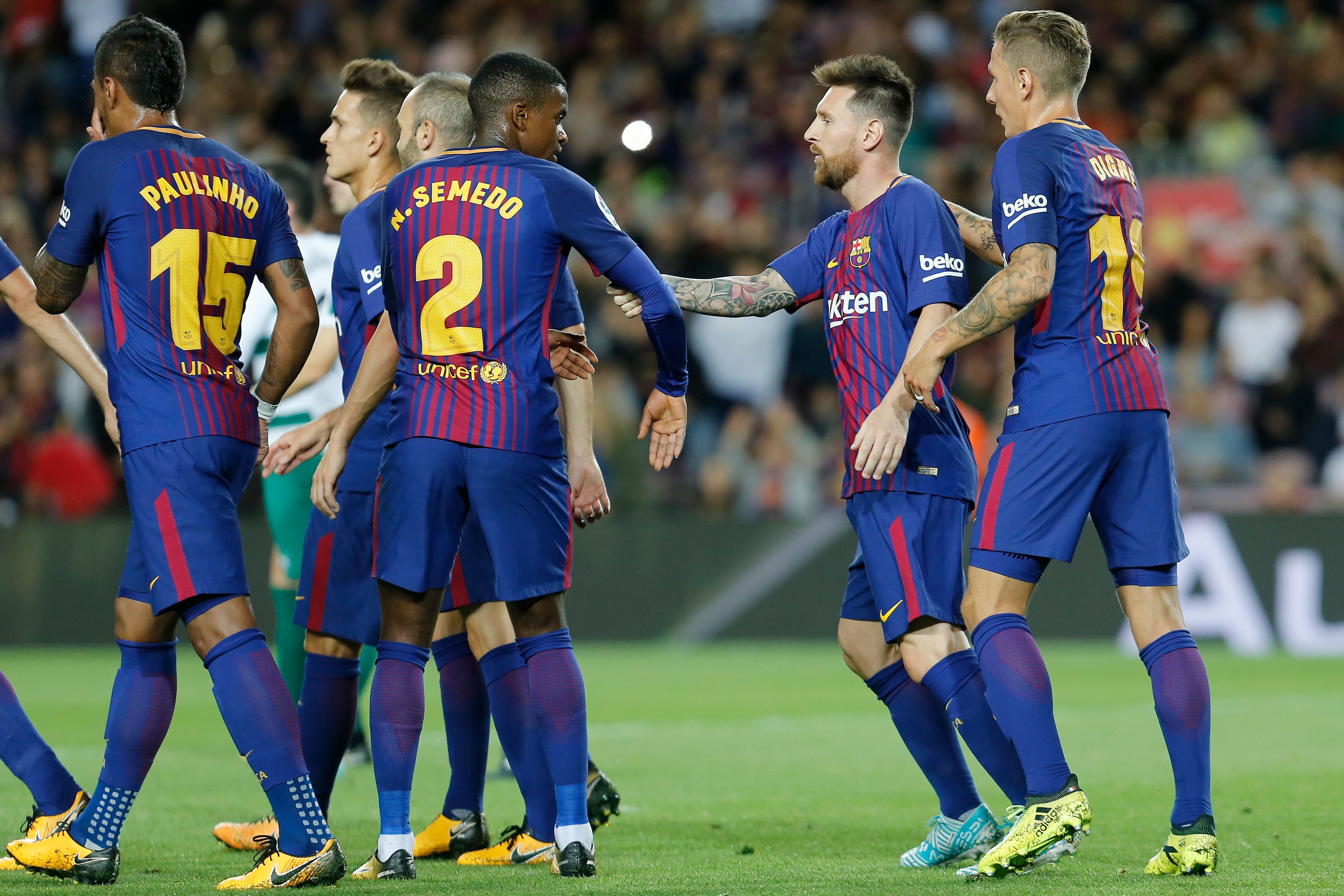 Barcelona's forward from Argentina Lionel Messi (2R) celebrates teammates after scoring during the Spanish league football match FC Barcelona against SD Eibar at the Camp Nou stadium in Barcelona on September 19, 2017. / AFP PHOTO / PAU BARRENA        (Photo credit should read PAU BARRENA/AFP/Getty Images)