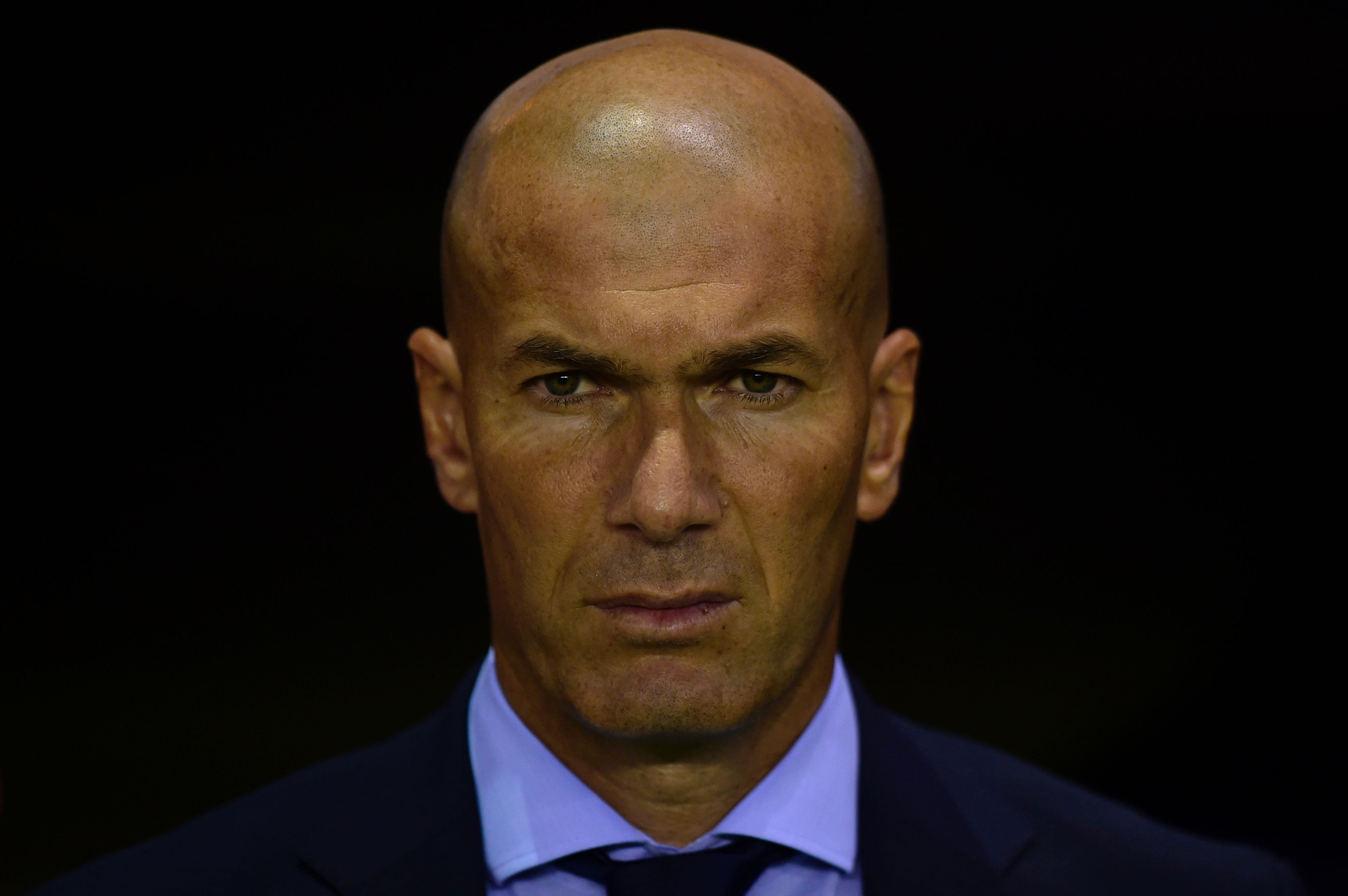 Real Madrid's French coach Zinedine Zidane observes a minute of silence in tribute to the victims of Barcelona and Cambrils attacks before the Spanish league footbal match RC Deportivo de la Coruna vs Real Madrid CF at the Municipal de Riazor stadium in La Coruna on August 20, 2017. / AFP PHOTO / MIGUEL RIOPA        (Photo credit should read MIGUEL RIOPA/AFP/Getty Images)