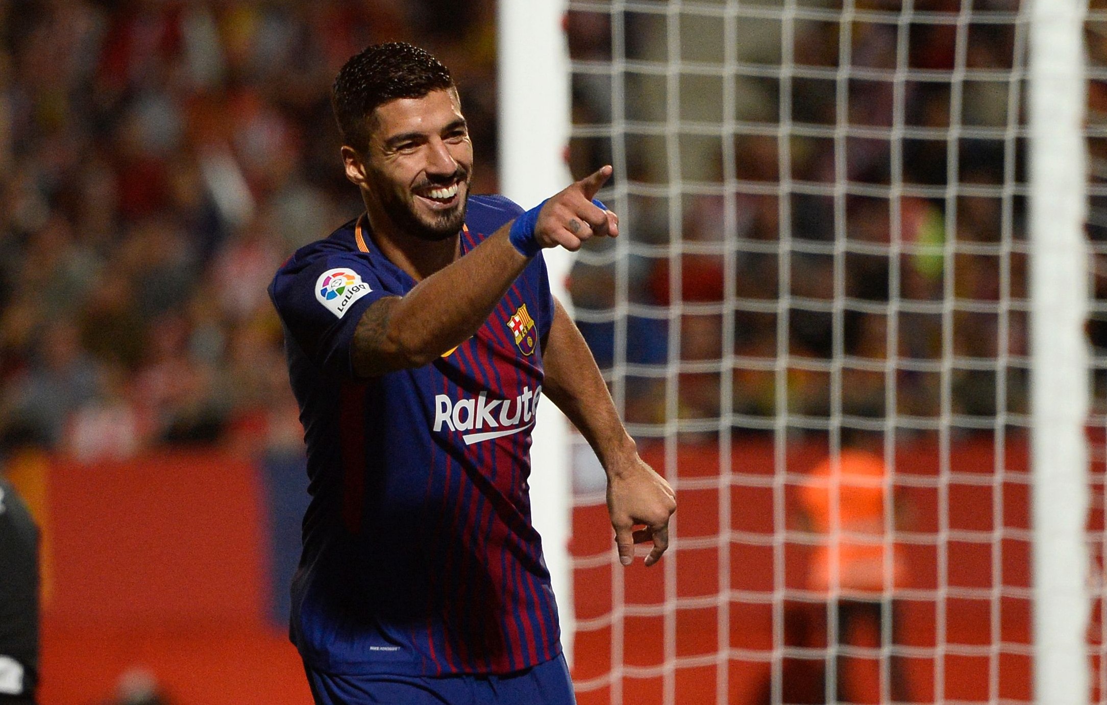 Barcelona's forward from Uruguay Luis Suarez celebrates after scoring during the Spanish league football match Girona FC vs FC Barcelona at the Montilivi stadium in Girona on September 23, 2017. / AFP PHOTO / Josep LAGO        (Photo credit should read JOSEP LAGO/AFP/Getty Images)