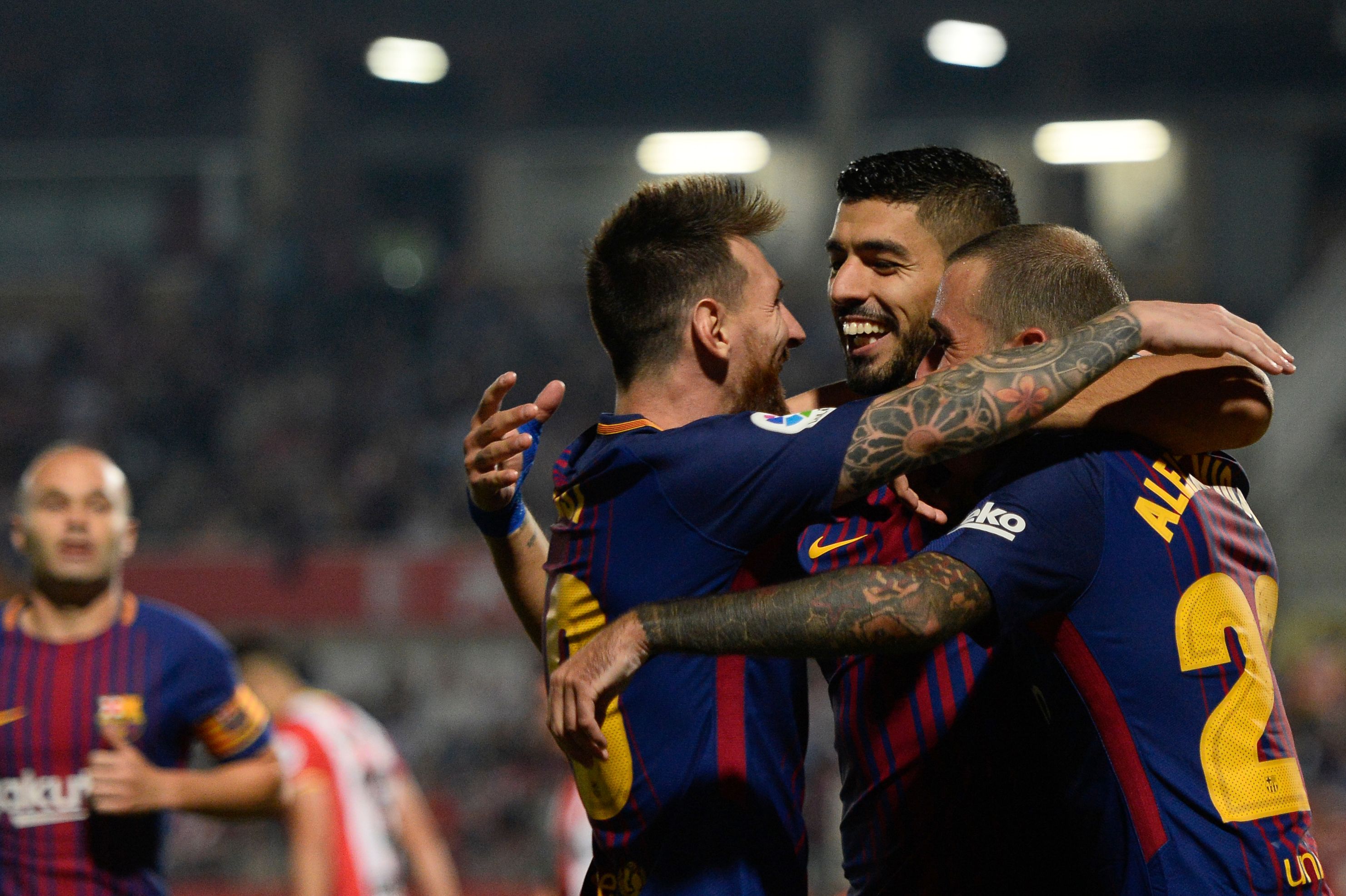 Barcelona's forward from Uruguay Luis Suarez (2ndR) celebrates with Barcelona's forward from Argentina Lionel Messi (2ndL) and a teammate after scoring during the Spanish league football match Girona FC vs FC Barcelona at the Montilivi stadium in Girona on September 23, 2017. / AFP PHOTO / Josep LAGO        (Photo credit should read JOSEP LAGO/AFP/Getty Images)
