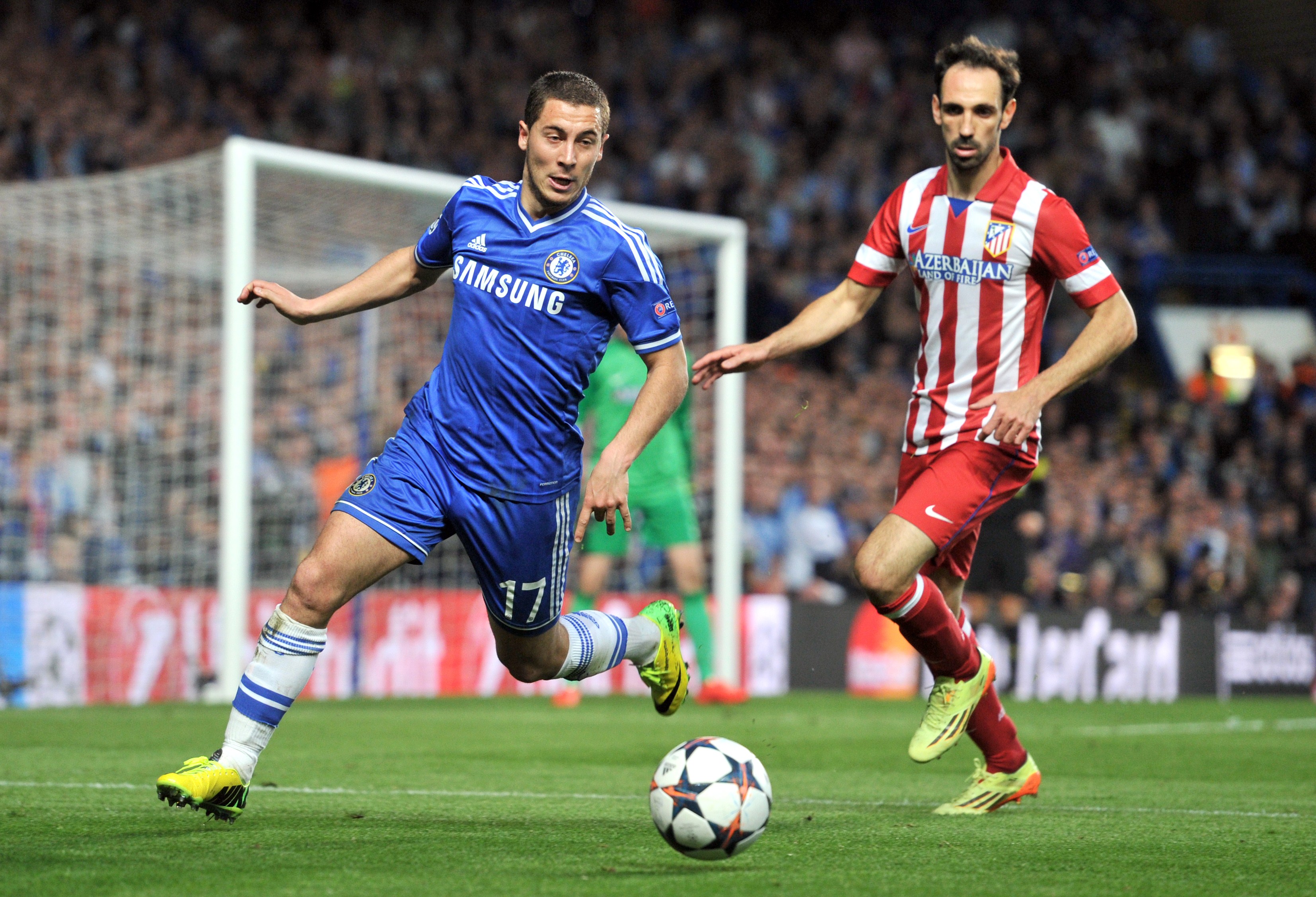 Chelsea's Belgian midfielder Eden Hazard (L) challenges Atletico Madrid's Spanish midfielder Juanfran during the UEFA Champions League semi-final second leg football match between Chelsea and Atletico Madrid at Stamford Bridge in London on April 30, 2014. AFP PHOTO / GLYN KIRK        (Photo credit should read GLYN KIRK/AFP/Getty Images)