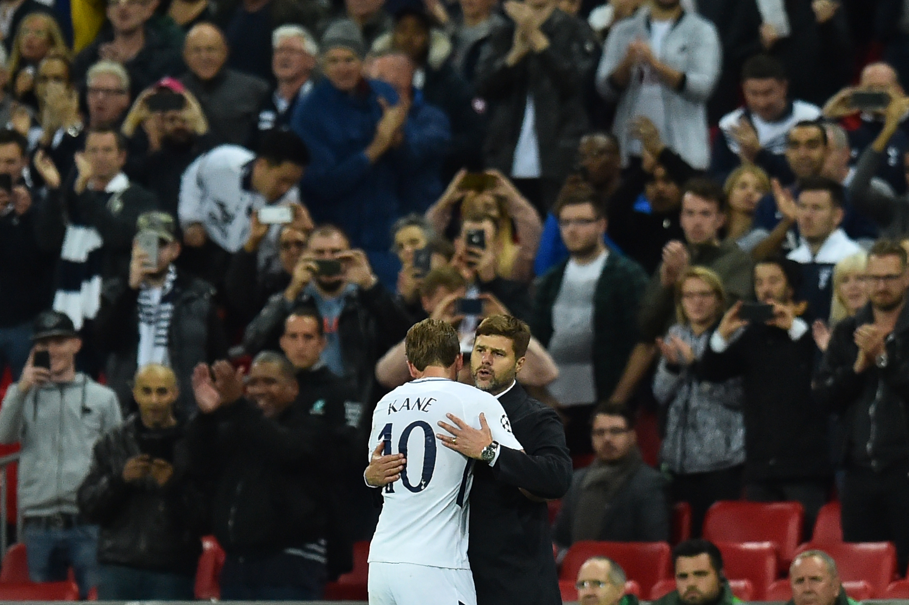 Tottenham Hotspur's English striker Harry Kane is embraced by Tottenham Hotspur's Argentinian head coach Mauricio Pochettino after being substituted during the UEFA Champions League Group H football match between Tottenham Hotspur and Borussia Dortmund at Wembley Stadium in London, on September 13, 2017. / AFP PHOTO / Glyn KIRK        (Photo credit should read GLYN KIRK/AFP/Getty Images)