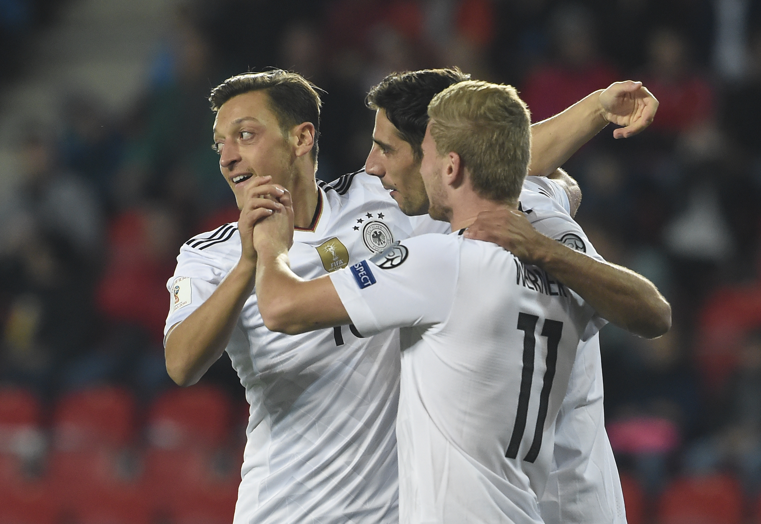 Germany's forward Timo Werner (R) celebrates with Germany's midfielder Mesut Ozil (L) and Germany's forward Lars Stindl scoring the opening goal during the FIFA World Cup 2018 qualification football match between Czech Republic and Germany in Plzen, Czech Republic on September 1, 2017. / AFP PHOTO / Michal Cizek / The erroneous mention[s] appearing in the metadata of this photo by Michal Cizek has been modified in AFP systems in the following manner: [Prague] instead of [Plzen]. Please immediately remove the erroneous mention[s] from all your online services and delete it (them) from your servers. If you have been authorized by AFP to distribute it (them) to third parties, please ensure that the same actions are carried out by them. Failure to promptly comply with these instructions will entail liability on your part for any continued or post notification usage. Therefore we thank you very much for all your attention and prompt action. We are sorry for the inconvenience this notification may cause and remain at your disposal for any further information you may require.        (Photo credit should read MICHAL CIZEK/AFP/Getty Images)