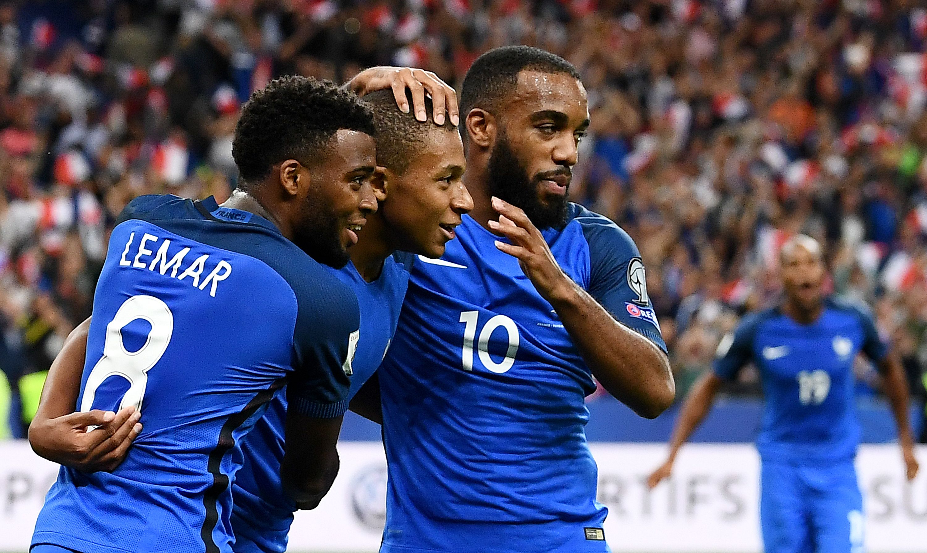 France's forward Kylian Mbappe (C) is congratuled by France's forward Thomas Lemar and France's forward Alexandre Lacazette (R) after scoring a goal during the FIFA World Cup 2018 qualifying football match France vs the Netherlands on August 31, 2017 at the Stade de France stadium in Saint-Denis, north of Paris.   / AFP PHOTO / FRANCK FIFE        (Photo credit should read FRANCK FIFE/AFP/Getty Images)