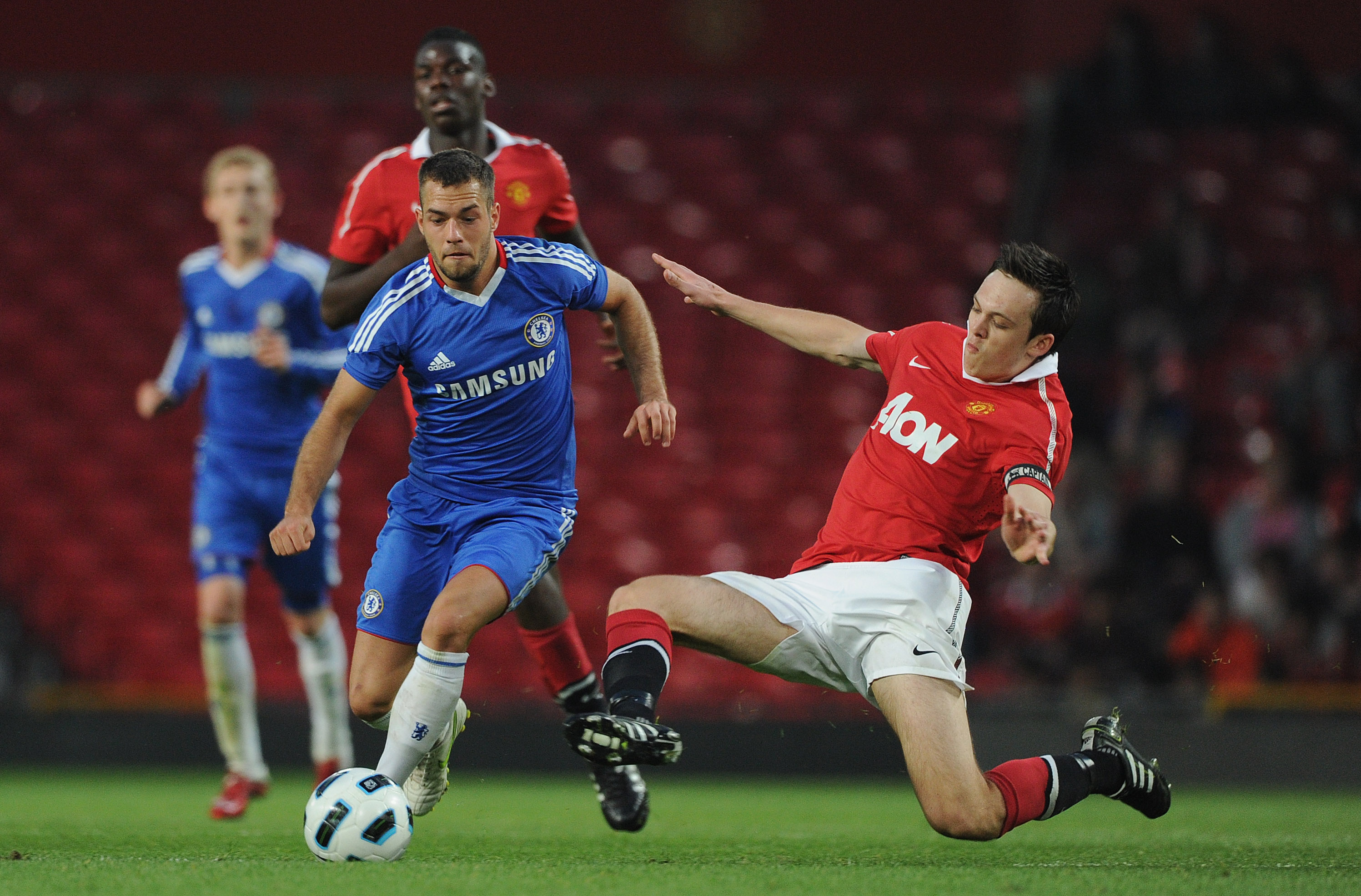 MANCHESTER, ENGLAND - APRIL 20: Milan Lalkovic of Chelsea is tackled by Tom Thorpe of Manchester United during the FA Youth Cup Semi Final 2nd Leg between Manchester United and Chelsea at Old Trafford on April 20, 2011 in Manchester, England.  (Photo by Michael Regan/Getty Images)