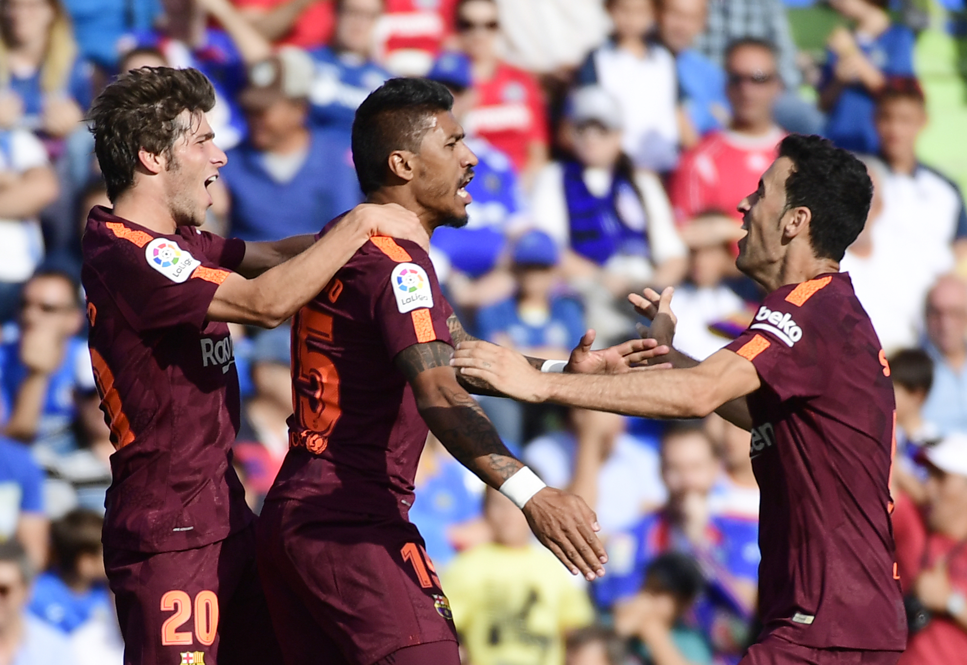 Barcelona's midfielder from Brazil Paulinho (C) celebrates a goal with Barcelona's midfielder from Spain Sergi Roberto (L) and Barcelona's midfielder from Spain Sergio Busquets during the Spanish league football match Getafe CF vs FC Barcelona at the Col. Alfonso Perez stadium in Getafe on September 16, 2017. / AFP PHOTO / PIERRE-PHILIPPE MARCOU        (Photo credit should read PIERRE-PHILIPPE MARCOU/AFP/Getty Images)