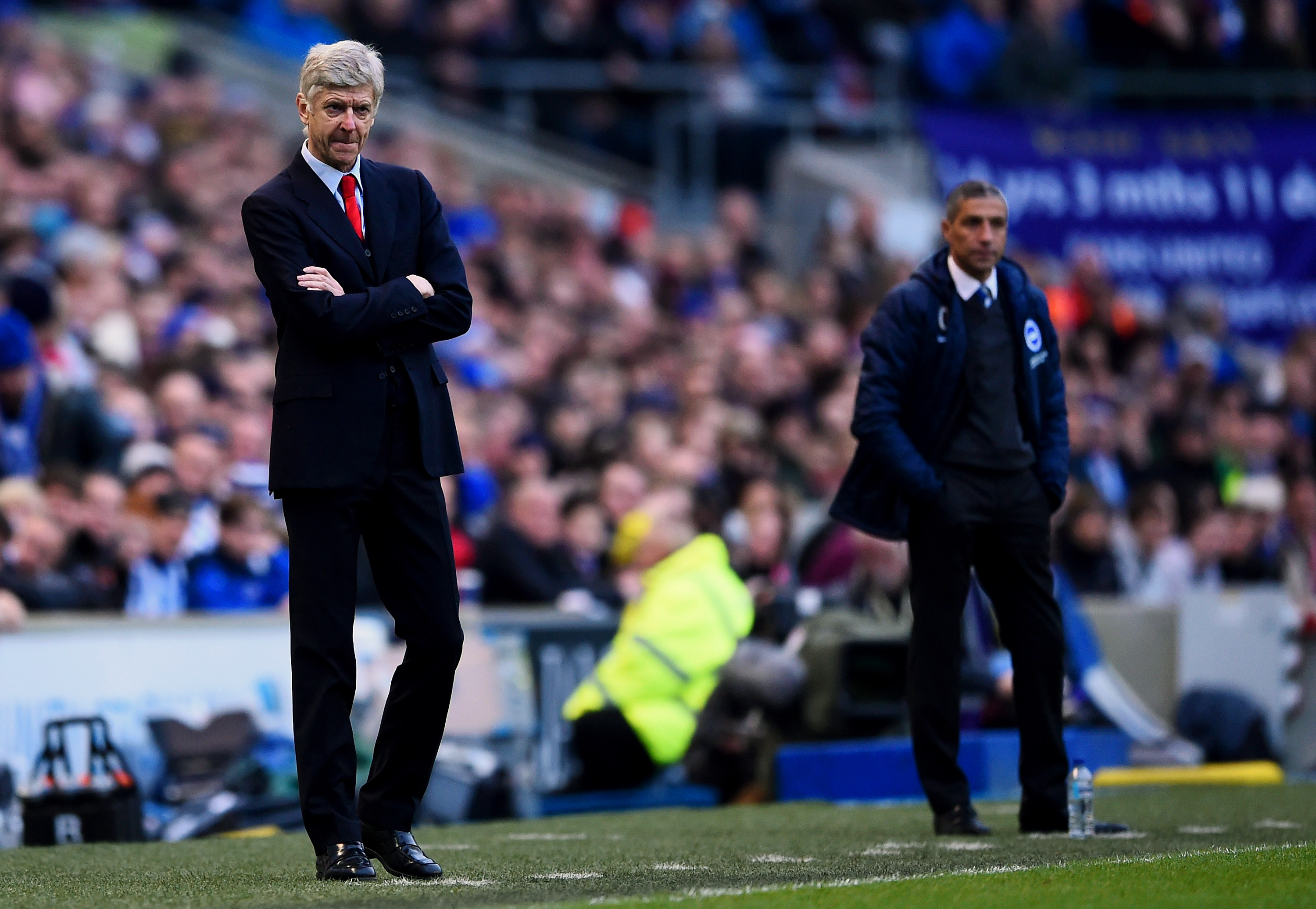 BRIGHTON, ENGLAND - JANUARY 25:  Arsene Wenger, manager of Arsenal watches the action on the touchline next to Chris Hughton, manager of Brighton during the FA Cup Fourth Round match between Brighton & Hove Albion and Arsenal at Amex Stadium on January 25, 2015 in Brighton, England.  (Photo by Mike Hewitt/Getty Images)