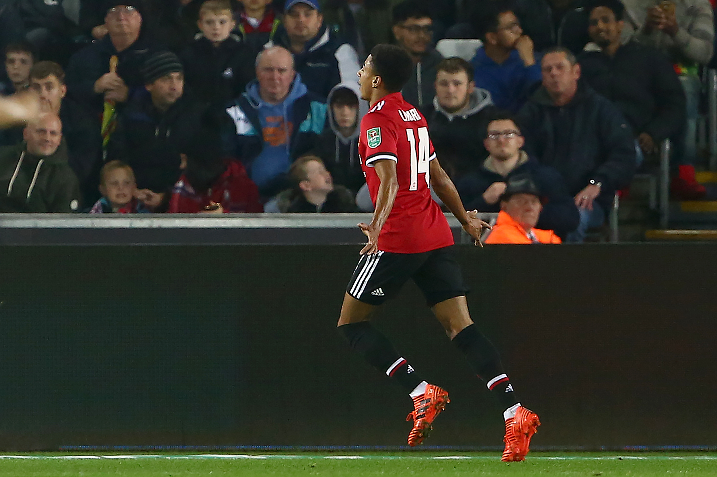 Manchester United's English midfielder Jesse Lingard celebrates scoring the opening goal during the English League Cup fourth round football match between Swansea City and Manchester United at The Liberty Stadium in Swansea, south Wales on October 24, 2017. / AFP PHOTO / Geoff CADDICK / RESTRICTED TO EDITORIAL USE. No use with unauthorized audio, video, data, fixture lists, club/league logos or 'live' services. Online in-match use limited to 75 images, no video emulation. No use in betting, games or single club/league/player publications.  /         (Photo credit should read GEOFF CADDICK/AFP/Getty Images)