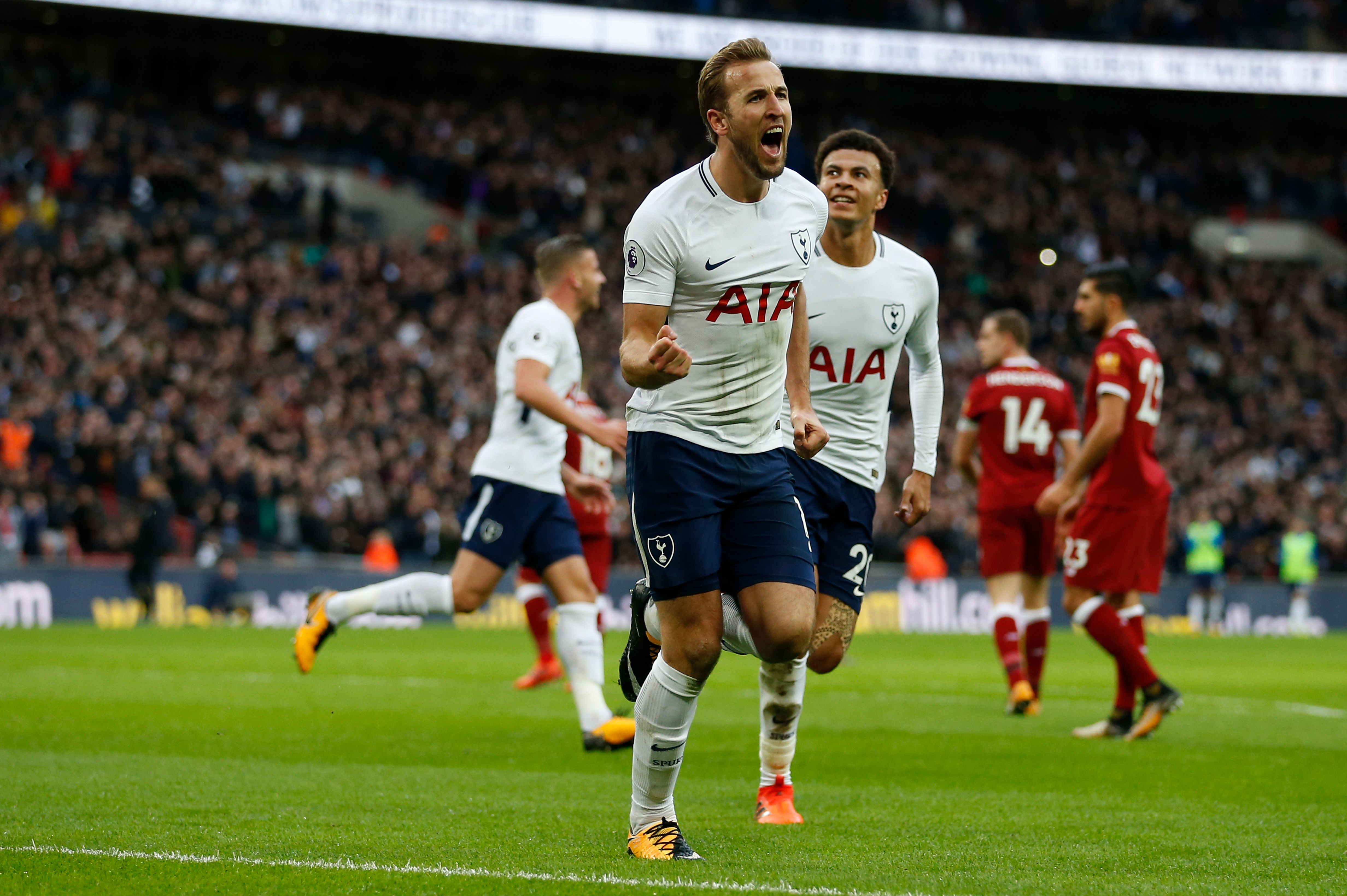 Tottenham Hotspur's English striker Harry Kane (C) celebrates after scoring their fourth goal during the English Premier League football match between Tottenham Hotspur and Liverpool at Wembley Stadium in London, on October 22, 2017. / AFP PHOTO / IKIMAGES / Ian KINGTON / RESTRICTED TO EDITORIAL USE. No use with unauthorized audio, video, data, fixture lists, club/league logos or 'live' services. Online in-match use limited to 45 images, no video emulation. No use in betting, games or single club/league/player publications.  /         (Photo credit should read IAN KINGTON/AFP/Getty Images)